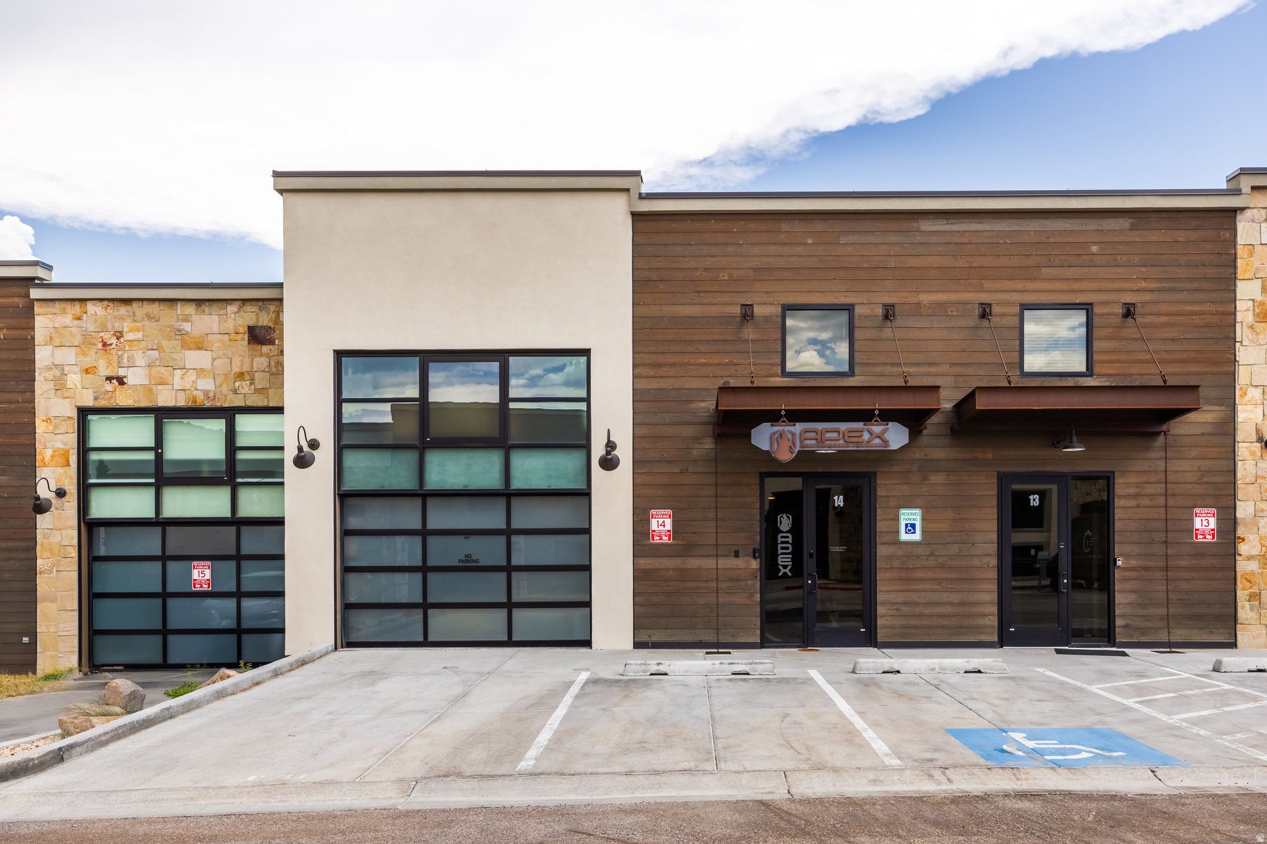 Welcome to a Rare Opportunity in Park City's Park East II & III Business Community. This versatile, modern mixed-use property offers the ultimate "live, work, play" lifestyle across 4,600 square feet and three thoughtfully designed levels. Zoned for light industrial use, it accommodates a wide range of commercial and residential possibilities. The main level features an expansive commercial space with soaring ceilings, gas heat, 3-phase power, and a spacious 3-car garage with potential for a 4th car or side-by-side. It's an ideal setup for a showroom, workshop, or creative studio. The lower level provides additional office, commercial, or storage space, offering even more flexibility for your business or operational needs. Upstairs, a fully approved ADU (Accessory Dwelling Unit) delivers a sleek studio-style apartment, complete with a full kitchen, open-concept living and sleeping area, and a full bathroom-perfect for a live-in owner, executive suite, or rental income. The property showcases custom steelwork throughout, blending modern aesthetics with structural integrity. Notably, the space has not been overbuilt, preserving the freedom for a new owner to further customize or expand to suit evolving needs-be it additional business use, creative development, or residential enhancement. Additional highlights include two assigned parking spaces and a private rooftop deck with hot tub-an exceptional amenity for entertaining or relaxing. Centrally located just minutes from Park City's historic Main Street, with convenient access to Highway 40 and Salt Lake City International Airport, this one-of-a-kind property seamlessly blends prime location, cutting-edge design, and limitless multi-use potential.