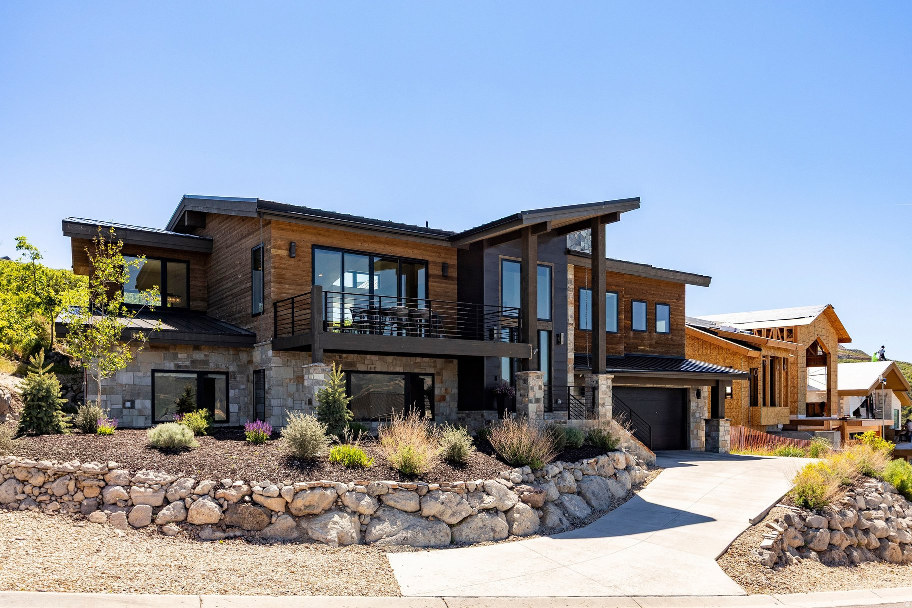 Located in the desirable Soaring Hawk community just minutes from Deer Valley Resort and Historic Main Street, 11418 White Tail Court offers the perfect blend of luxury, comfort, and mountain living. This newer-construction mountain contemporary home features 4 bedrooms, 3 bathrooms, and 3,418 square feet of thoughtfully designed living space, showcasing breathtaking views of the Jordanelle Reservoir and the slopes of Deer Valley East Village. Expansive windows frame the surrounding scenery while filling the home with natural light. High-end finishes throughout complement the open and inviting floor plan, designed for both everyday living and entertaining. The spacious lower-level family room provides an ideal gathering space for family and friends and includes a wine fridge for effortless hosting. An oversized 2-car garage offers ample room for vehicles, outdoor gear, and additional storage. Step outside onto the expansive view deck and enjoy a glass of wine while taking in the stunning mountain and reservoir vistas, or relax in the quiet, flat backyard, perfect for summertime BBQs and outdoor entertaining. Whether you're spending the day skiing, hiking, biking, or exploring the restaurants and shops of Park City, this exceptional location places world-class recreation just moments away. Sold fully furnished and turnkey, this beautifully appointed home is ready for immediate enjoyment as a full-time residence or vacation retreat.