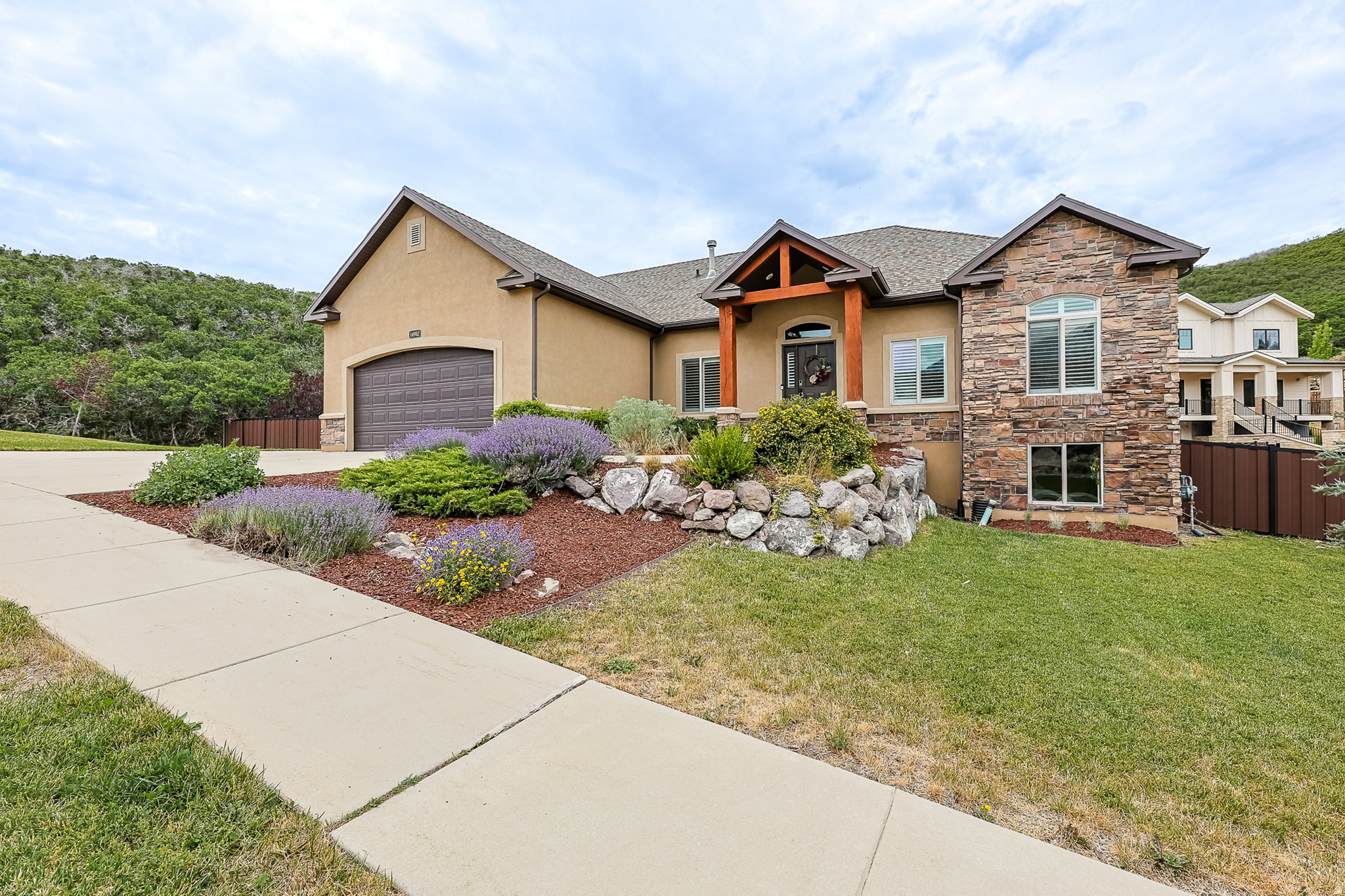 Welcome to single-level living in the highly sought-after SunCrest community! Nestled on a peaceful, private 0.71-acre lot, this beautifully updated rambler offers stunning views, exceptional privacy, and a lifestyle you'll love.  The backyard is designed for relaxing and entertaining with water-wise landscaping, a custom fire pit, and new fencing. You will enjoy watching the wildlife from your oasis. An energy-saving whole-house attic fan cools the home in minutes, helping reduce air conditioning costs during the summer.  Recent updates include new kitchen appliances, water heater, water softener, fresh paint, and new carpet, making this home truly move-in ready.  Enjoy SunCrest's outstanding HOA amenities, including a community pool, clubhouse, fitness center, parks, playgrounds, tennis and pickle ball courts, plus year-round community events. Miles of scenic hiking and biking trails are just outside your door, and the home is located within a highly rated school district.  Experience the perfect combination of privacy, breathtaking surroundings, and an active mountain community in one of Draper's most desirable neighborhoods. All information to be verified by buyer.