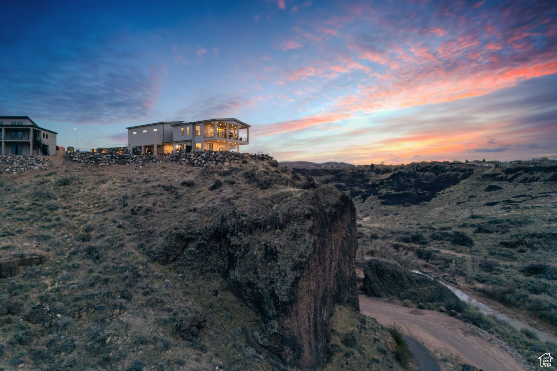 This remarkable home offers much more than meets the eye, providing a truly unique living experience. Nestled above the stunning Confluence Park protected by the Red Cliffs Desert Reserve, with direct access to hiking trails right out your back door. An Anasazi cave once occupied by Paiute and Anasazi Indians is an historical treasure right on this property. This custom-designed home boasts breathtaking 270-degree unimpeded views from its unique perch atop a peninsula basalt cliff. Borders protected lands w/hiking trails outside your door, stunning panoramas of the Virgin River, a dramatic volcanic gorge, and inspiring Pine Valley Mtns.   The main level provides seamless living with a spacious primary ensuite, a guest bedroom, an office, and an expansive kitchen, dining, and living area-perfect for both relaxation and entertaining. Sliding doors and windows open up to a covered patio, allowing you to take in the awe-inspiring natural landscape and views.The walkout basement adds even more value with private bedrooms, a kitchenette, a bar, a cozy den, ample entertainment space, and plenty of storage. Outside, the resort-style backyard with a refreshing pool and an outdoor fireplace offers the ultimate in fun and relaxation. For those seeking additional income, this property includes three separate casitas for hosting guests OR could be used for a nightly rental business if it is your primary residence.  To top it all off, this estate features extensive storage, a 20'x50'RV garage with a 14'x14' door, and a huge workshop space-ideal for all your hobbies and projects. Multiple garages could be used for boats and other toys or LOTS of cars.
