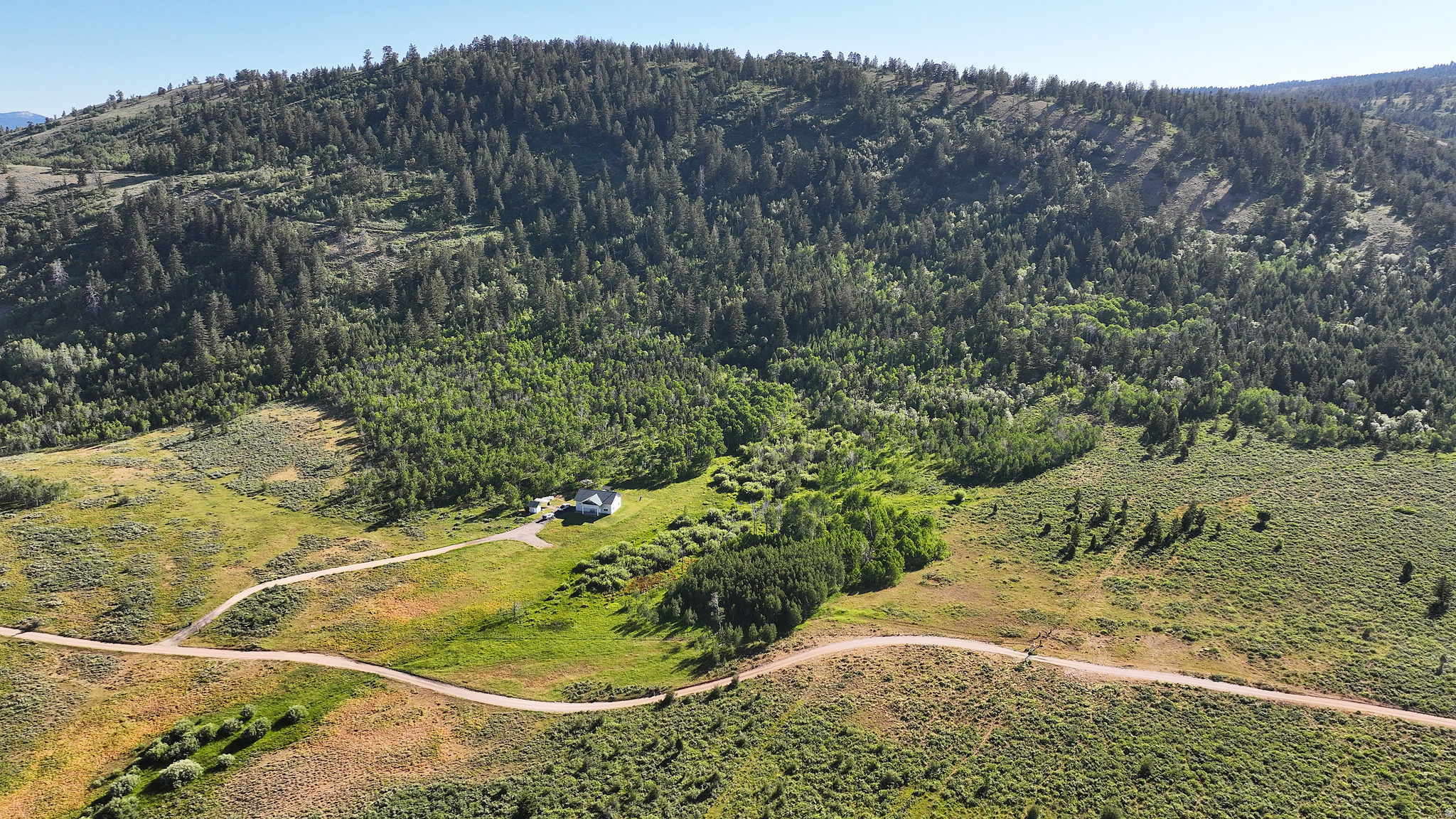 Stauffer Canyon Turnkey Cabin on 40 Acres with Solar and Well  -Survey will be completed prior to sale -Additional 40-acre parcel available - Seasonal county road access 7.2 miles off HWY 36 - 3000+- SF, 2-bedroom, 2.5 bath cabin built in 2001 - Full off the grid capability with solar panels, battery room & Kohler generator - Well, 3 hydrants & 120 gallon buried bladder tank ensuring constant pressure - Panoramic views of Bear River Mountain Range - Winter access requires a snowmachine - Partially fenced  -- Enjoy expansive canyon views and four-season recreation with this high country off the grid cabin tucked in the heart of the Bear River Mountain Range.  Beautifully set against the majestic rolling hills with seasonal access just over seven miles off State Highway 36, this turnkey Stauffer Canyon two bedroom, two and a half bath, 3000 +- square foot cabin is well-maintained and sits on forty acres.  The terrain offers endless exploration both on and off the property and opportunities to invite family and friends to set up camp in your own backyard.   The creek and natural vegetation, including wild berries, provide shelter and habitat for wildlife such as mule deer, elk, moose and upland game which frequent the property.  Experience the serenity of the outdoors year-round on the covered front porch and upper covered deck.   The main level front porch is the full lenth of the cabin and offers ample space for greeting guests and seating.  Relax to the gentle sounds of the aspen leaves rustling in the breeze and  enjoy the fresh mountain air.  The stars in the night sky seem to shine especially bright.  Enjoy stargazing without all of the light pollution of the city.    Bear Lake State Park and Marina, known as the Caribbean of the Rocky Mountains for its turquoise blue water, is just thirty three miles away.  Float, fish or swim along the nearby Bear River and return to warm up by the campfire or wood burning stove and enjoy wildlife viewing from the privacy of your own backyard. This is an outdoor recreation enthusiast's paradise with Cache National Forest close by.  Access to miles of dirt roads and trails to explore backpacking, mountain biking, horseback riding, cruising in ATVs, big game and upland game hunting.  Winter access requires a snowmachine and opens the door to a magical winter wonderland to explore snowmobiling, cross country skiing, fat tire biking and snowshoeing.    Equipped with full off the grid capability, including pedestal solar panels, a separate building with battery room and Kohler generator.   The low maintenance fiberglass siding and roof with InsulSafe insulation and partially enclosed upper deck add to the value and peace of mind especially as a recreational property.  In addition to the full bath inside the cabin, a separate plumbed shower house equipped with electricity, water heater, two showers, two sinks and two toilets.comes in handy when hosting guests.  The open floor plan with nine foot ceilings on the main level, a vaulted ceiling on the upper level and natural light streaming in through the windows creates a welcoming glow against the warm wood paneling.  In the fall, the lush evergreen carpeted ridge is particularly vibrant against the golden leaves and white trunks of the aspens.  This may be just the recreational property you have been waiting for.