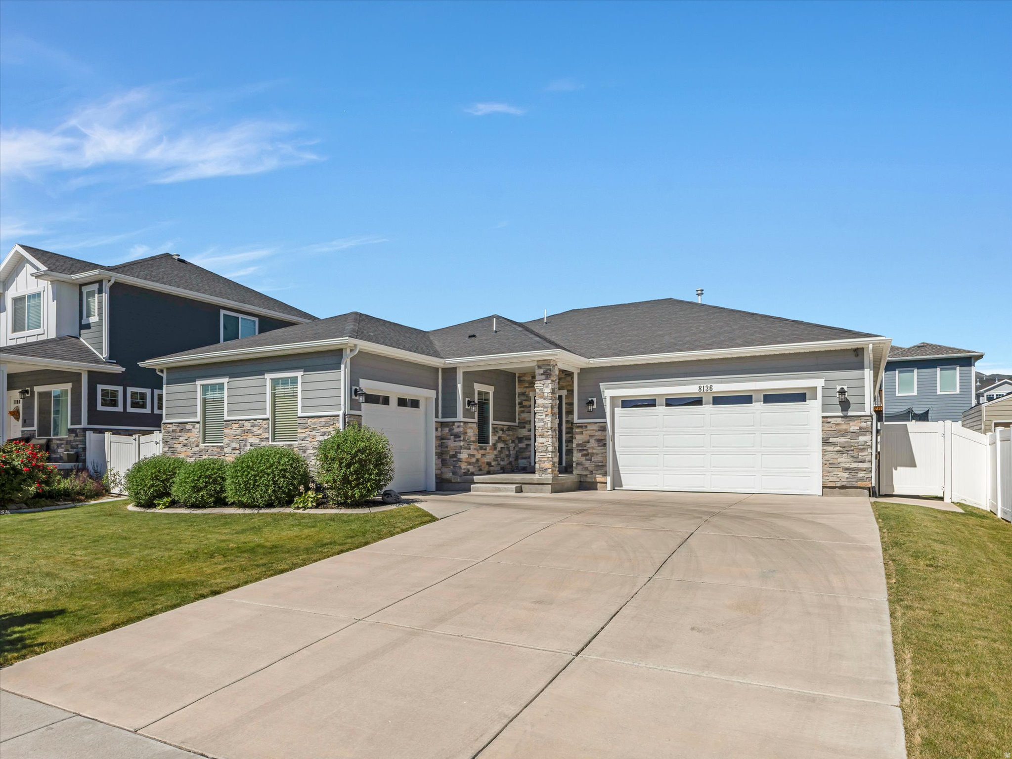 Welcome Home to this thoughtfully designed rambler offering the comfort and convenience of true main-floor living in one of West Jordan's most desirable locations. With the primary suite, two additional bedrooms, a full bathroom, laundry room, and all primary living spaces located on the main level, this home combines exceptional functionality with easy everyday living. Home Depot, Smith's Marketplace, and the highly anticipated new Trader Joe's are all just minutes away, placing shopping, dining, and daily conveniences right at your fingertips. The open-concept layout creates a warm and inviting atmosphere where the spacious living room flows seamlessly into the kitchen and dining area. Designed with both style and practicality in mind, the kitchen features white cabinetry, stainless steel appliances, designer pendant lighting, and an oversized walk-in pantry with remarkable storage and organization. The spacious primary suite serves as a private retreat with a luxurious ensuite bathroom featuring dual vanities, a separate soaker tub, walk-in shower, and generous walk-in closet. The fully finished basement expands the home's versatility with a kitchenette featuring a sink, microwave, and full-size refrigerator, a dedicated theater room, two additional bedrooms, and a beautifully appointed  bathroom with euro-glass shower. Outside, the fully fenced and meticulously maintained backyard offers a covered patio ideal for entertaining, outdoor dining, or relaxing evenings at home. Complete with a three-car garage and an exceptional location close to shopping, dining, and amenities, this home offers the perfect balance of comfort, convenience, and livability.