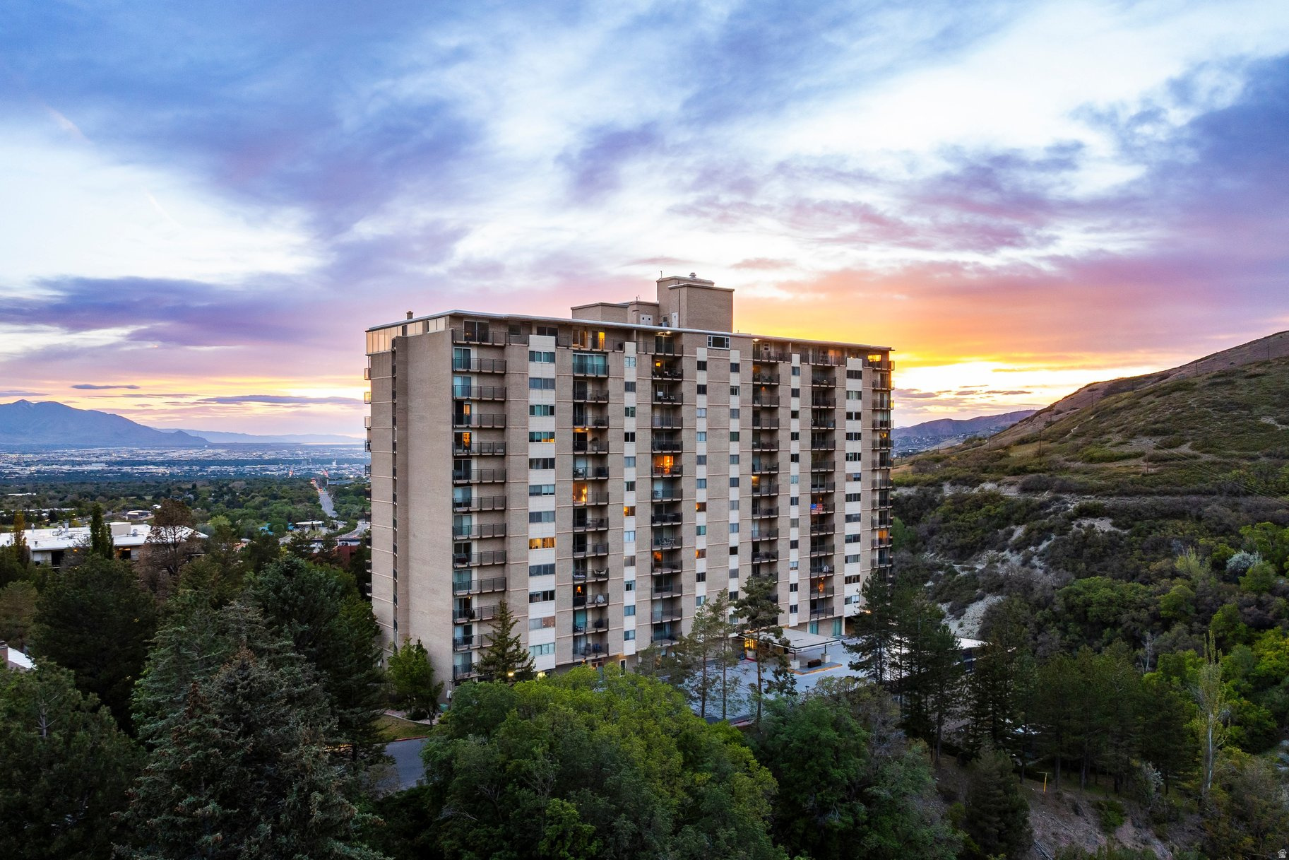 Situated at the mouth of Emigration Canyon in the St. Mary's neighborhood, this Canyon Crest condo offers beautiful views of the Salt Lake Valley all the way to the Oquirrh Mountains. Located on the third floor, this two-bedroom, two-bathroom residence features renovations throughout the condo, including a new kitchen in 2019 and new bathrooms in 2009. The recently renovated kitchen was opened to the living and dining rooms, with all new appliances and custom-built maple cabinetry and quartz countertops. The renovated main bathroom has a tiled shower with a bamboo wood floor, while the primary bath includes a custom-tiled shower and bathroom floor. Both bathrooms have new vanities and sinks (double in main) with travertine counter tops. Other than the bathrooms, the entire condo had oak hardwood flooring installed in all rooms, along with new paint throughout. A large private deck provides space to relax and take in the scenery. Each bedroom enjoys valley views as well.. The home is set within a secure, controlled-access building with a welcoming lobby and on-site management and support staff. HOA amenities include a pool, lawn area, gas grills, picnic space, exercise room, self-service car wash, and ample guest parking. Trash, water, sewer, insurance, gas, and electricity are all included in the HOA fee. The condo has been set up for Google Fiber. The unit also has two assigned parking spaces in a heated, underground garage. A large above-floor storage cabinet is immediately adjacent to each parking space (A and B floors), and a double-size private storage room with electrical power is also available on the A-level parking floor. The Canyon Crest Condominiums is a short distance to Donner Trail Park; it is also ideally located near the University of Utah and its Health Sciences Center, including University Hospital and Research Park. The condo is also near other major hospitals, Hogle Zoo, This is the Place Heritage Park, Bonneville Golf Course, and Coach Mike's Tennis Center. The condo has easy access to hiking and biking trails including the Bonneville Shoreline Trail, a quick drive downtown Salt Lake City and to the Salt Lake International Airport.