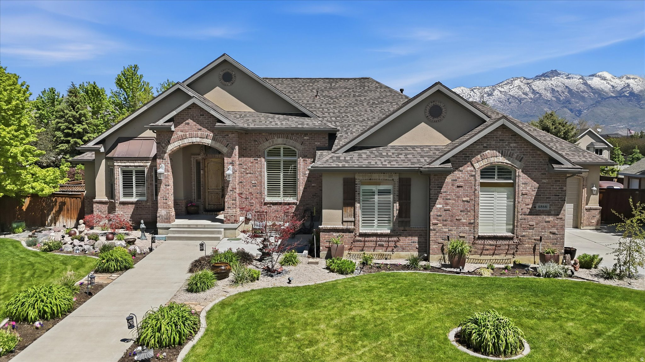 Tucked away in the highly sought-after Highland Ranch community, this extraordinary Highland estate offers the perfect blend of luxury, comfort, privacy, and exceptional entertaining space. Featuring 6 spacious bedrooms and 3.5 bathrooms, this beautifully maintained home is ideal for multigenerational living, a private home office, or simply enjoying room to spread out and relax. A new fiberglass roof with a transferable warranty adds long-term value and peace of mind, while all bathrooms have been recently updated with beautiful modern finishes. The true centerpiece of this property is the breathtaking resort-style backyard - a destination all its own. With a stunning 40' x 16' swimming pool, expansive deck, inground hot tub, firepit gathering area, mature trees, and lush landscaping, this private outdoor retreat has hosted numerous wedding receptions and unforgettable celebrations. Whether entertaining large groups or enjoying a peaceful evening under the stars, the setting is simply spectacular. Beautiful mountain views from the backyard create the perfect finishing touch. Inside, the home is warm, inviting, and exceptionally cared for, featuring fireplaces both upstairs and downstairs, generous storage throughout, and flexible living spaces designed for today's lifestyle. The front and backyard are meticulously maintained, while the large outdoor shed provides convenient storage for yard and pool equipment. The sprinkler system is connected to Highland City irrigation for added efficiency. You'll also enjoy harvesting fresh raspberries, boysenberries, and almonds from your own yard each summer - a rare and charming feature that makes this property feel truly special. Located just minutes from shopping, restaurants, grocery stores, Alpine Highway, and I-15, this home combines peaceful luxury living with unbeatable convenience. Highland Ranch is known for its beautifully maintained homes, welcoming atmosphere, and strong sense of community. This is more than a home - it's a private retreat, an entertainer's dream, and a place where lasting memories are made.  Square footage figures are provided as a courtesy estimate only and were obtained from an appraisal.  Buyer is advised to obtain an independent measurement.