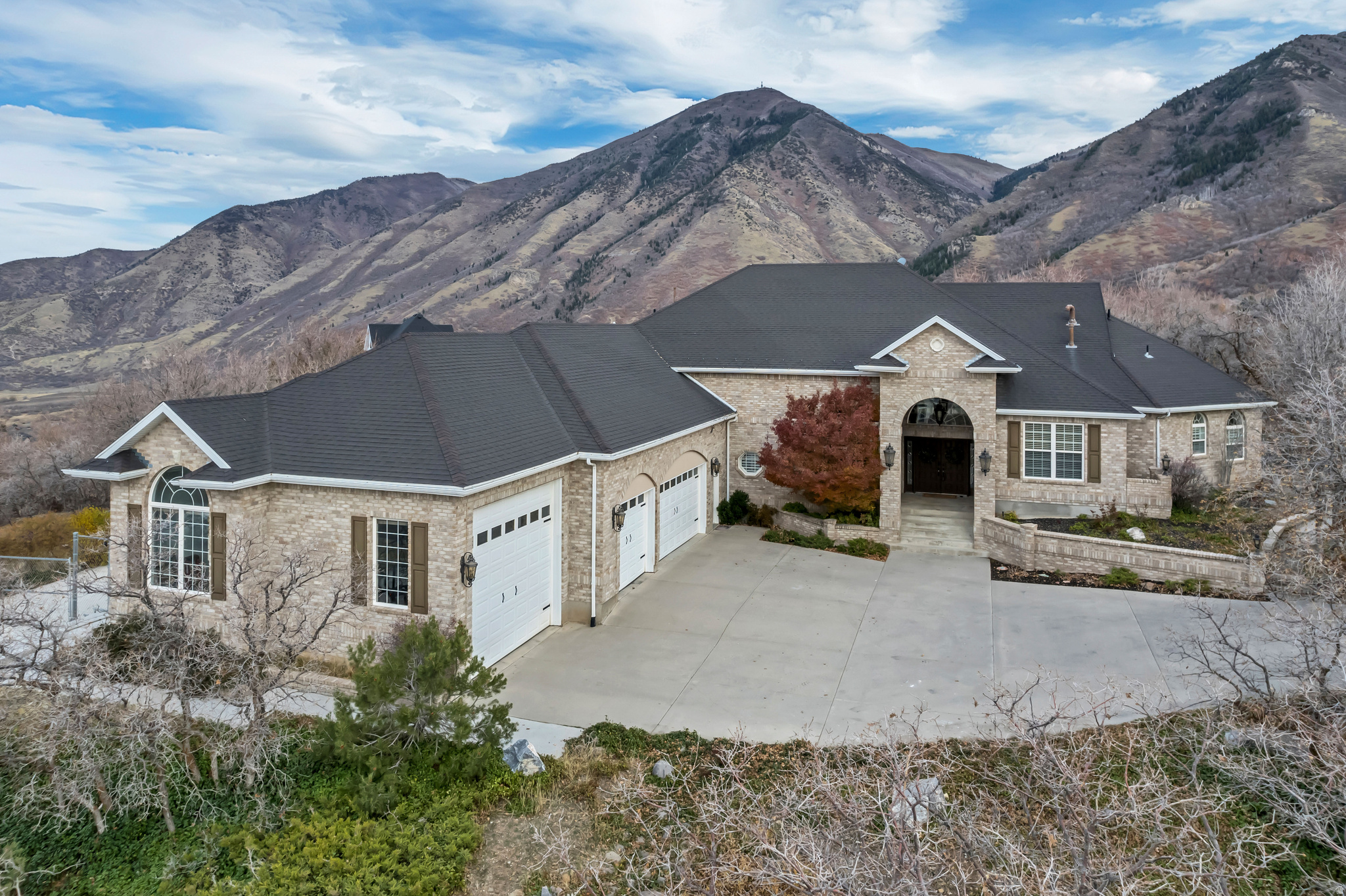 Welcome to this stunning Woodland Hills home nestled on 1 acre with breathtaking mountain views! This spacious 5-bedroom, 4.5-bath residence offers comfort, style, and functionality throughout. The open-concept kitchen features double ovens, ample counter space, and flows seamlessly into the living areas-perfect for entertaining. Enjoy the large sunroom year-round with built-in heaters and panoramic views. The primary suite includes a luxurious ensuite bath and has its own dedicated furnace and water heater. The home also features a private mother-in-law apartment with a separate entrance. The 4-car heated garage provides plenty of space for vehicles and storage, with additional RV parking for all your toys. Additional highlights include large windows for abundant natural light and roof heat strips to keep snow off during winter. Experience peaceful country living with modern amenities.   Buyer to verify all.  Square footage figures are provided as a courtesy estimate only and were obtained from county records .  Buyer is advised to obtain an independent measurement.