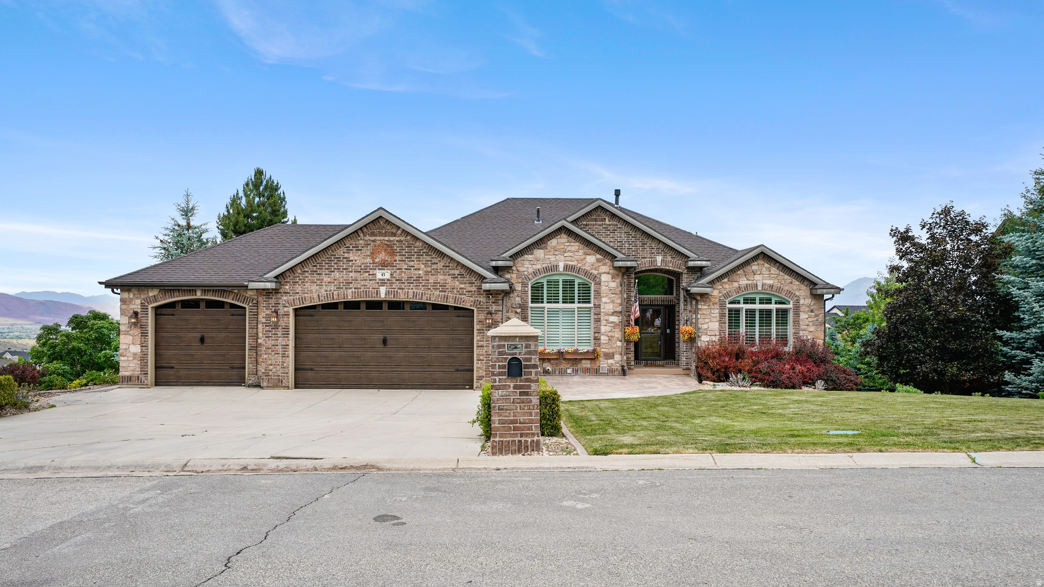 Views abound from this stunning 5,280 sq ft custom rambler home located on a beautiful 1.26-acre view lot.  Enjoy the unobstructed panoramic views and blazing sunsets of the valley from your private sunroom, Owner's suite, kitchen and great room.  This home has just about everything you could want.  Formal living room & private office with mountain views, sunroom, great room with fireplace, spacious main kitchen with double wall ovens, gas cooktop range, microwave, granite counter tops, custom cabinetry, dishwasher and inlayed tile floors.  The main floor Grand Owner's Suite features a gas log fireplace, grand owner's bathroom with separate tub and shower, double basin vanity and large walk-in closet (and don't forget those valley views from your bedroom windows).  The main floor also boasts a formal entry, spacious laundry room, large dining area and an additional bedroom and full bath plus the private guest 1/2 bath.  Downstairs you will find 2 more bedrooms, 2 more full bathrooms, walk-out basement entry to the back yard, gas fireplace, 2 large gathering/game rooms, a 2nd full kitchen with granite countertops, a 3rd room that's an indoor hot tub and 1/2 bath that could be converted into an additional bedroom.  This area makes a great mother-in-apartment of ADU. There's a 2nd laundry room and storage room PLUS a HUGE, FULLY FURNISHED THEATER ROOM featuring STADIUM SEATING and ALL AUDIO/VISUAL EQUIPMENT for the ultimate entertainment experience.  Don't forget the 3-car garage with workbench and professional landscaping surrounding the immediate home that compliments the natural and undisturbed vegetation on this large 1.26-acre lot and the Gazebo with stunning views.  Square footage figures are provided as a courtesy estimate only and were obtained from building plans.  Buyers are advised to obtain an independent measurement. Information is deemed reliable but not guaranteed, Buyer is advised to verify all information presented to their satisfaction.  Amenities include 2 refrigerators, 3 fireplaces, 4 rooms with French doors, Sunroom, Washer and Dryer, Movie Theater including A/V equipment and furniture, 2 kitchens, 2 laundry rooms, Private home office and so much more.