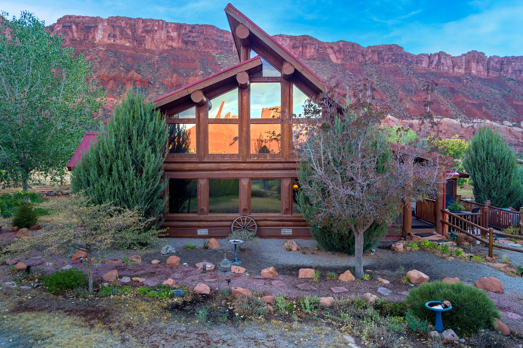 ADVENTURE, RECOVER & REPEAT Built by the desert and enjoyed by you, this Castle Valley retreat is designed for recreating, recovering, creating, and installing a legacy of adventure. Originally built in 2002 and expanded in 2005, the log cabin offers a two-story layout overlooking valley, red rock, and La Sal mountain views. The loft features old-growth juniper details, a sitting area, small office nook, closet, and private enclosed balcony for quiet mornings or dark sky evenings. A 20' x 40' enclosed screened porch adds 800 square feet of seasonal living and entertaining space. The detached two-car garage addition includes deep garage bays, a fully equipped gym, half bath, upstairs office, and spacious game room with flexibility for hobbies, guests, or remote work. Outside, the property unfolds into a private desert garden oasis with approximately 150 trees, an extensive irrigation infrastructure, landscaping and covered RV parking. Walking paths connect sitting areas, bird feeders, planters, pergola spaces, yard art, and a 10' x 20' tool shed. The large stone patio and outdoor kitchen frame sweeping views toward Porcupine Rim, an ideal setting for outdoor dining, storytelling, and stargazing. Castle Valley is known for its close-knit community, monthly gatherings, garden sharing, annual Gourd Festival, and designation as a Dark Sky community. Water rights included. Buyer to verify all information including square footage and acreage. Square footage figures are provided as a courtesy estimate only and were obtained from the tax assessment records.  Buyer is advised to obtain an independent measurement.