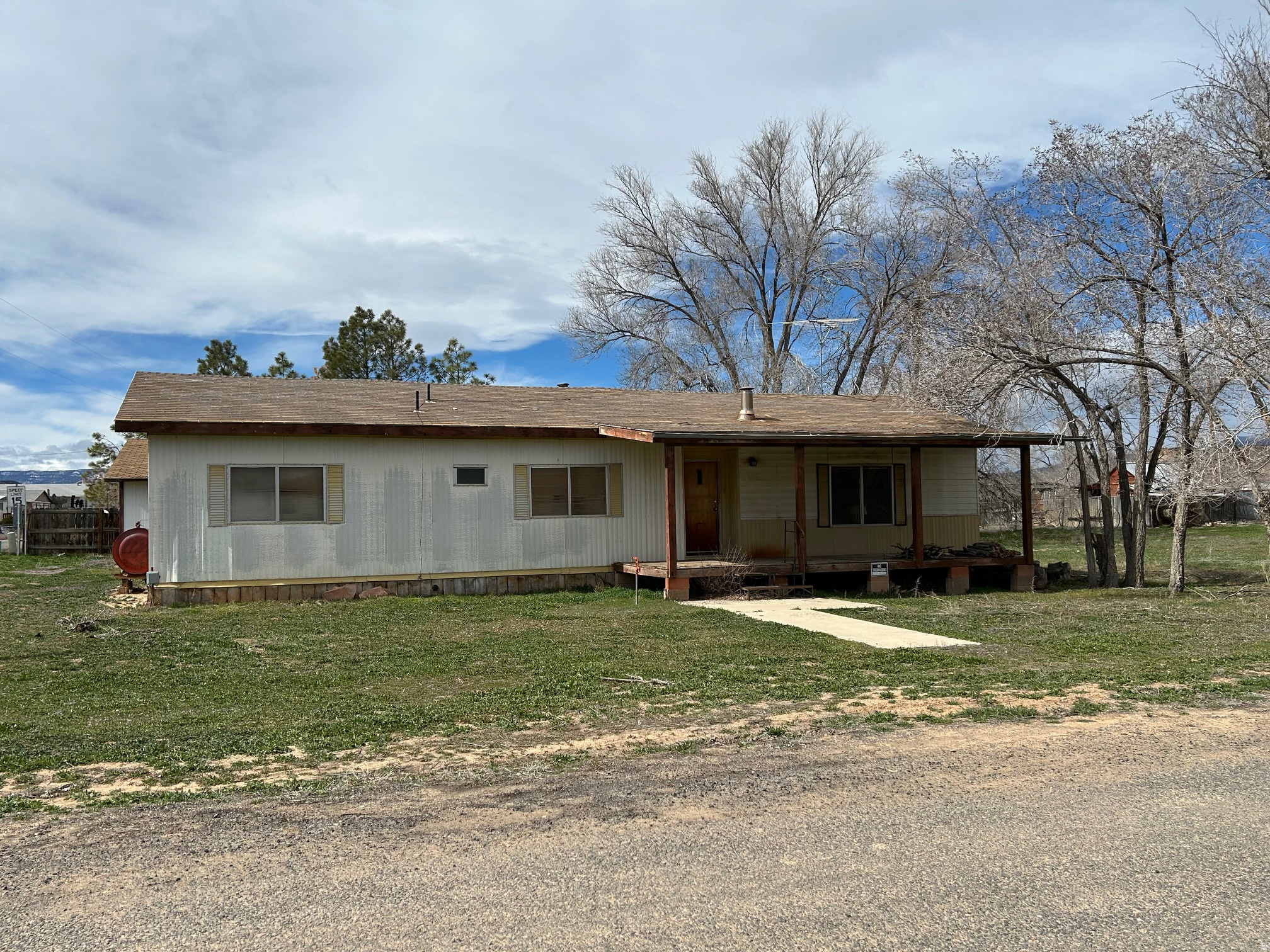 Huge price reduction! Great value for a stick built 2 car garage on nice 1/4 acre lot with views, shed and mobile home. Great starter home or easy recreational getaway in the Heart of the Escalante Grand Staircase Nat'l Monument. Minutes from Mountains, slot canyons and world-class hiking. Turn key with all furnishings & appliances included. Home was updated in the 90's, large primary bedroom with spacious bathroom and closets.  Wood stove and covered back deck off the kitchen for country gatherings. Situated on a large corner lot. Needs a little TLC - Perfect opportunity to enjoy the slow pace of life at an affordable price!
