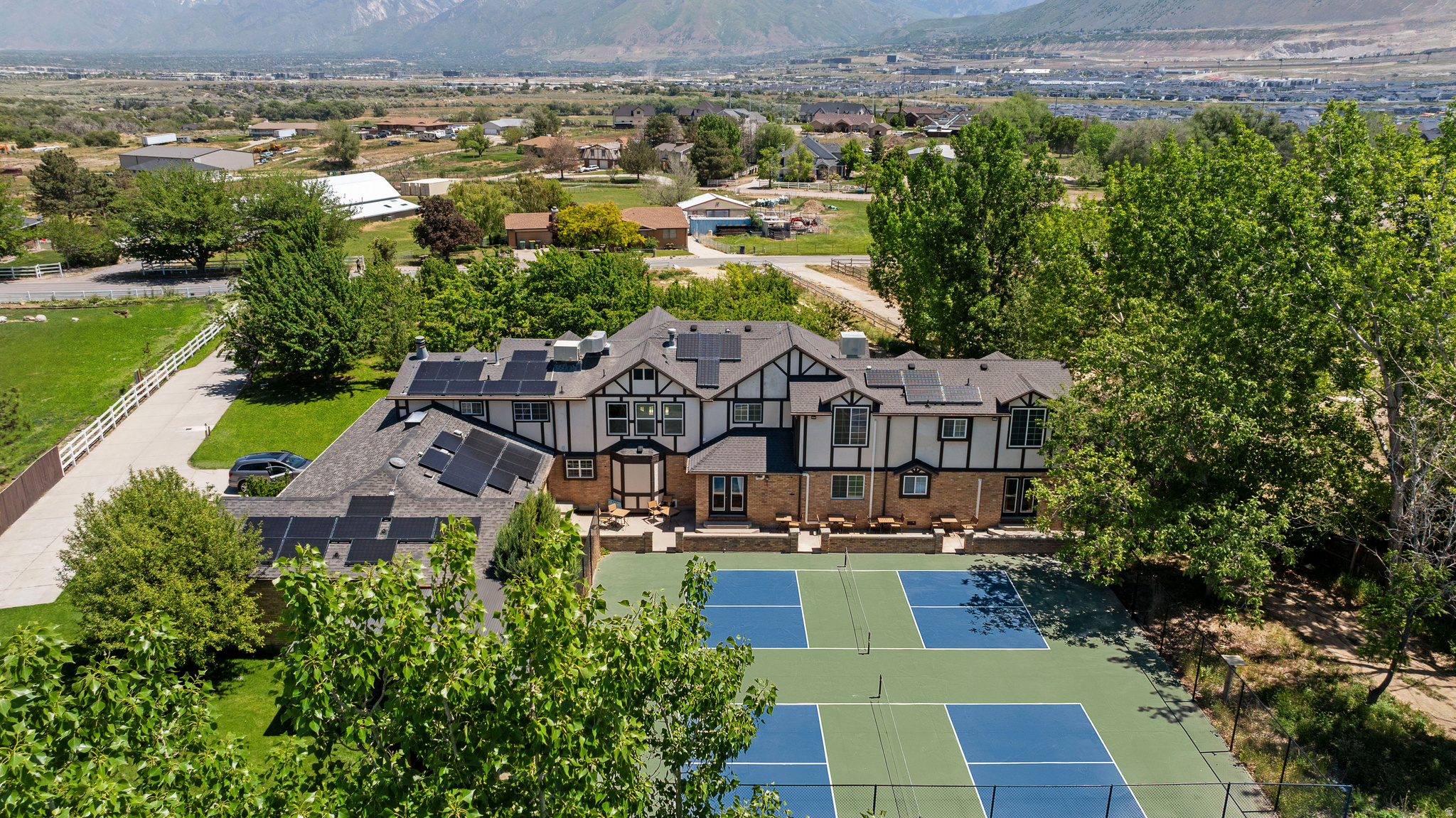 2+ acre Bluffdale estate with orchard, vineyard, and stunning views. Seller financing available with a minimum 20% down. Featuring double pickleball courts and a multi-use sport court ready for basketball and volleyball, this property is built for active lifestyles. The grounds include a mature fruit orchard (apples, peaches, cherries, apricots, plums & pears) and a grape-producing vineyard-ideal for crafting homemade juice, jams, or your own wine label. Enjoy expansive patios with breathtaking views-perfect for relaxing or hosting gatherings. Inside, you'll find 10 bedrooms, 7 bathrooms, and 2 full chef's kitchens, with a separately accessed attached residence, making it ideal for multi-generational living or rental flexibility. Additional highlights include main-level bedrooms, private office, an oversized basement, 3 laundry areas, zoned HVAC + radiant heat, solar panels, culinary and irrigation water shares, and ample space for RV/boat parking and guests. A large barn/shop offers customization for hobbies or storage. With room to expand-add a pool, host events, or grow your dream lifestyle-this estate is a rare blend of comfort, versatility, and opportunity. Schedule your private showing today!