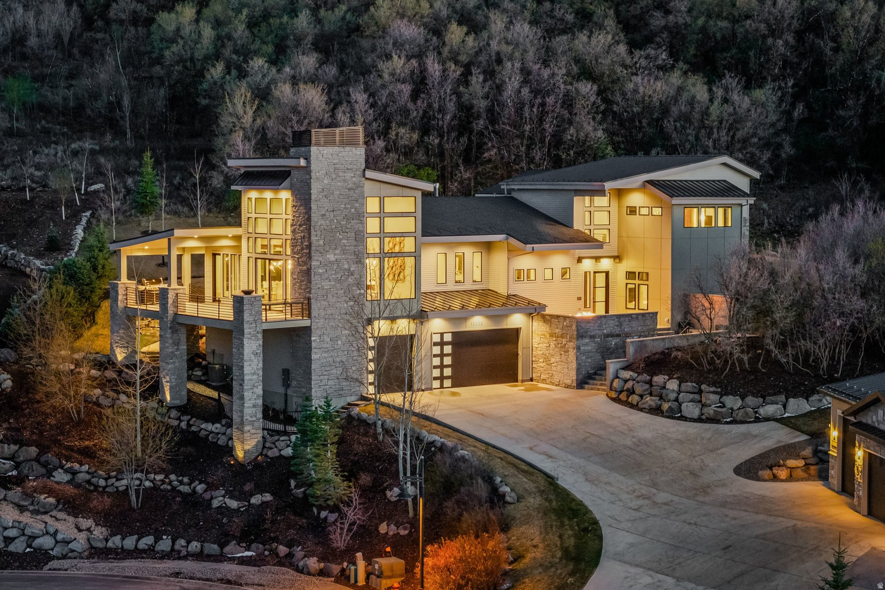 Sweeping views, exceptional privacy, and a thoughtfully designed floor plan make this Park City area retreat ideal for both entertaining and year-round adventure. Featuring 5 generously sized ensuite bedrooms, 2 family rooms, and multiple outdoor living spaces, the home blends comfort, functionality, and mountain style in every detail.  The open-concept living, dining, and kitchen area creates the perfect gathering space, complemented by a butler's pantry, expansive windows, high end finishes, and seamless access to outdoor decks and patios. Whether hosting friends on the large partially covered deck, fire pit patio, or relaxing in the private hot tub surrounded by mature trees and open space, the home offers spaces for every mood and occasion.  A fully decked-out 6-bed bunk room adds a fun and memorable touch, while the smart layout provides excellent separation and privacy throughout the home. Currently configured to sleep up to 19 guests, the property is equally suited as a legacy family retreat or luxury rental opportunity, with short-term rentals allowed. Set at the end of a quiet cul-de-sac, the home backs to a 14-acre open space preserve and hiking trail, creating a sense of peace, privacy, and direct access to the outdoors. Frequent wildlife sightings, including deer and moose, further enhance the mountain retreat setting. Offered fully furnished with high-end furnishings, this turnkey property is ready to enjoy from day one. Conveniently located just minutes from the new East Deer Valley Village, Jordanelle Reservoir, and Historic Main Street Park City, and only 35 minutes from Salt Lake City International Airport, this is mountain living at its best.