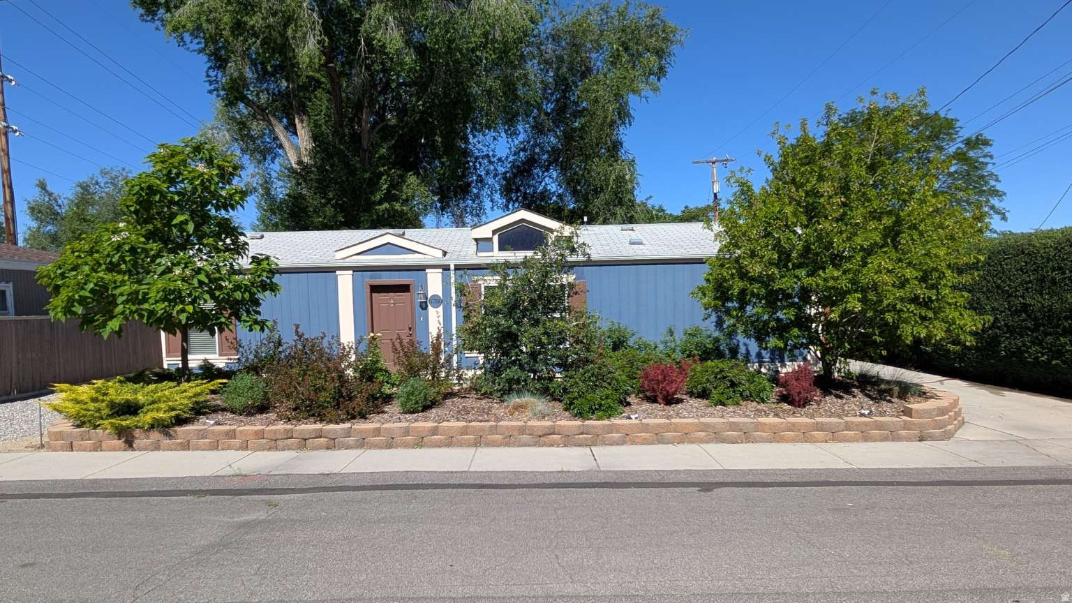 Comfortable three-bedroom, two-bath house located on a quiet street facing a park. Large, fenced backyard with several mature trees providing shade.