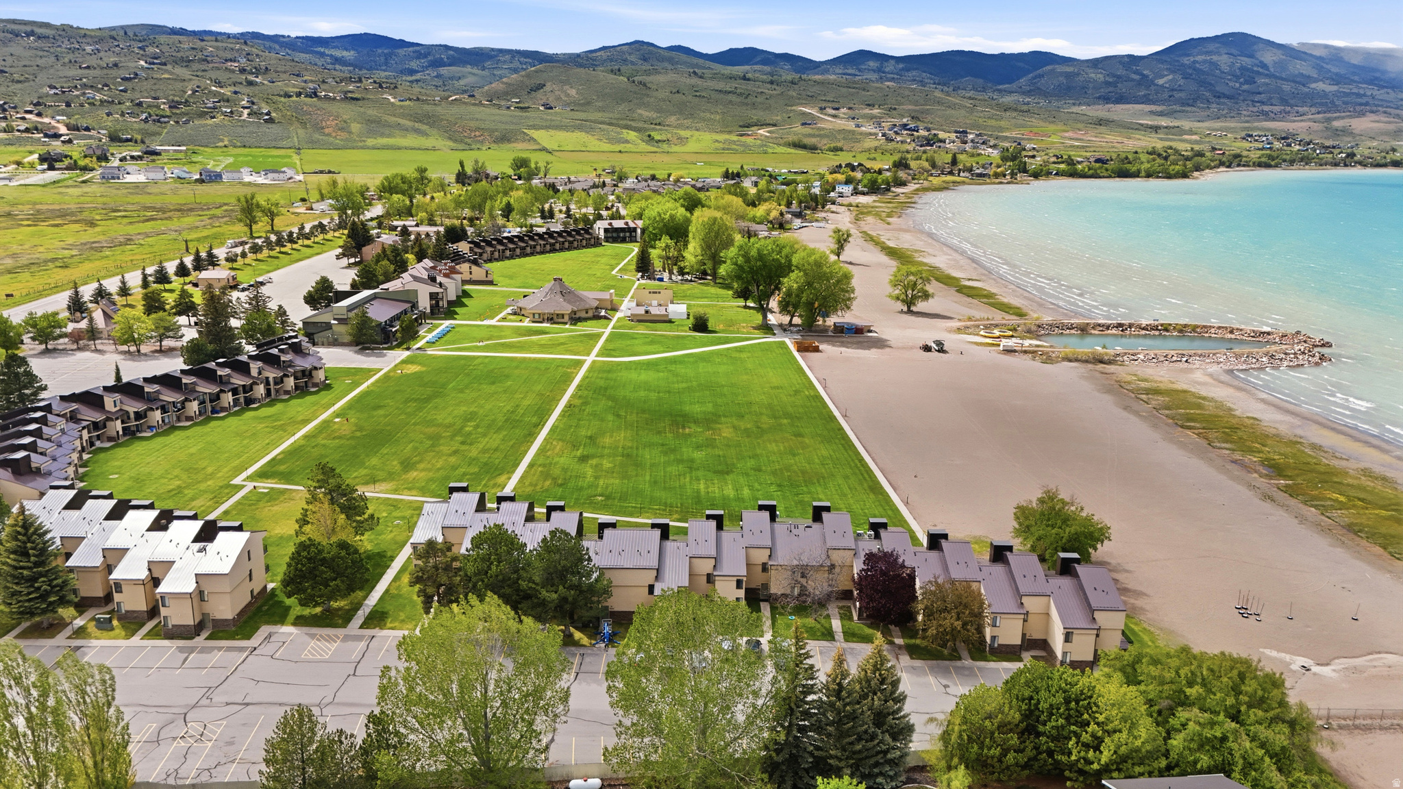 Some come to Bear Lake for the beach. Others come for the views. Here, you can enjoy both. Step outside your patio and you're just moments from the shared lawn, beach, pool, hot tub, pickleball courts, and everything that makes Ideal Beach one of Bear Lake's favorite destinations. Designed for making memories from the moment you arrive, this fully furnished main-level condo offers two bedrooms, two full bathrooms, a spacious living area, full kitchen, covered patio, and beautiful lake and mountain views. Whether you're spending the weekend, the summer, or sharing it with family and friends for years to come, it's a place that's ready to be enjoyed. A brand-new metal roof provides added peace of mind, while the established rental pool already has strong summer bookings in place. (Buyer to honor the existing rental pool participation through the current rental term ending September 7, 2026). Neighboring units are also available, creating a rare opportunity for extended families, friends, or investors looking to secure adjoining ownership in one of Garden City's most desirable resort communities. Square footage figures are provided as a courtesy estimate only and were obtained from county records. Buyer is advised to obtain an independent measurement.