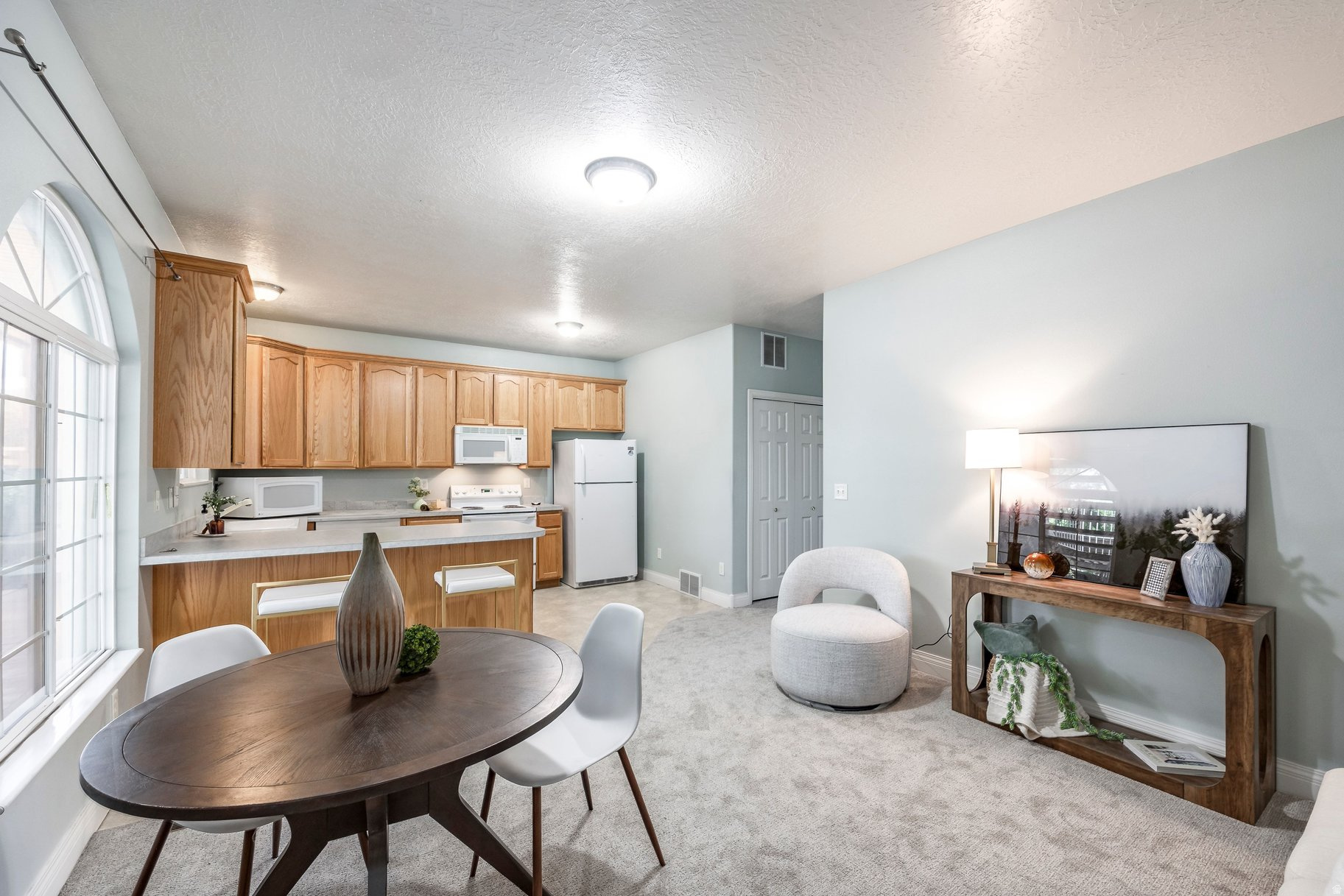 Ground-level condo with access from the primary bedroom to a covered patio and open grassy area; a genuinely rare find in a condo. Both bedrooms are en-suite with two full bathrooms. With lots of natural light, brand new carpet throughout, this condo feels bright and new inside. Bonus: in-unit laundry with washer and dryer included. Only one owner has lived in this condo since it was built! HOA offers a secure, gated community, covers water, sewer, trash, snow removal, and landscaping and allows pets! A pavilion for all your event- hosting needs and a large grassy area for your pets are added benefits. Rentals allowed up to the community's 20% cap. Plenty of storage with a storage closet right outside your unit.  South Salt Lake sits at the center of the valley. Sugar House park and Parley's Nature Reserve are just minutes away. Forest Dale Golf Course is less than a mile away. Big and Little Cottonwood Canyons are only 20 -25 minutes from your doorstep. Park City is 35 to 40 minutes. Quick access to both I-15 and I-215! You can't go wrong with this location.  All information herein is deemed reliable but is not guaranteed. Buyer is responsible to verify all listing information, including square feet/acreage, to buyer's own satisfaction.