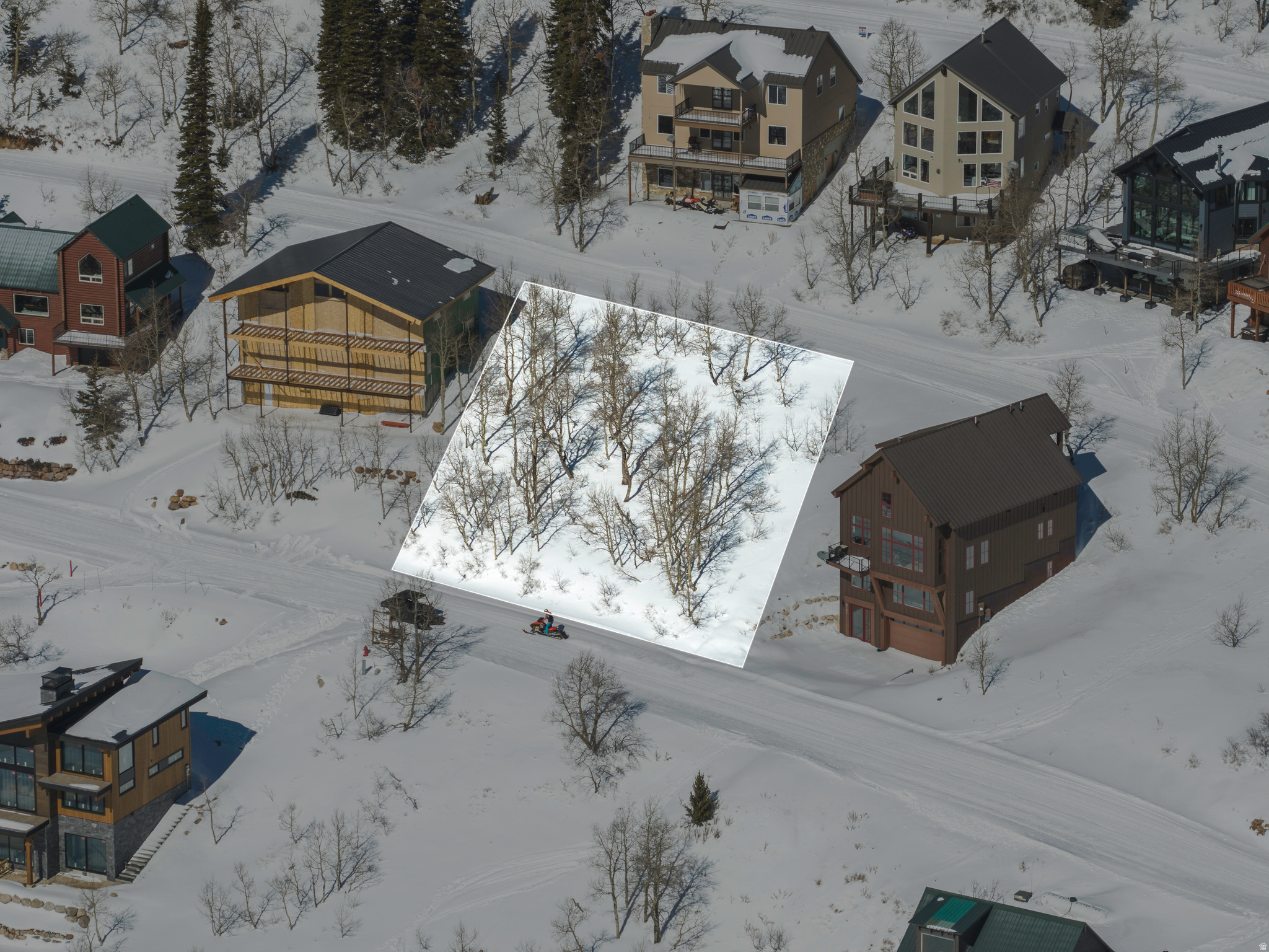 This premier building lot at Powder Mountain Ski Resort offers unparalleled ski-in/ski-out access directly from the Slow Poke ski trail, located on a relatively level parcel ideal for constructing your dream residence within the exclusive gated community of Powder Mountain West. Furthermore, it provides immediate access to an extensive network of hiking and mountain biking trails for your summer recreational pursuits.