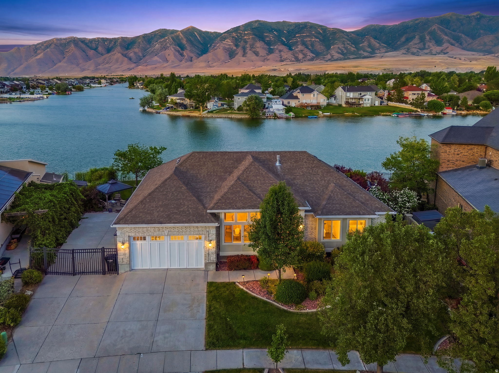 Luxury Waterfront Living with Unforgettable Mountain Views  Experience the rare opportunity to own a beautifully appointed waterfront home in the highly sought-after Stansbury Park community, where peaceful lakefront living meets everyday convenience. Just a short drive from Salt Lake City International Airport, downtown Salt Lake City, world-class skiing, and endless outdoor recreation, this exceptional property offers a lifestyle that is as relaxing as it is connected. Imagine beginning your mornings with coffee overlooking the lake, spending afternoons paddleboarding or kayaking from your backyard, and ending each day with spectacular sunsets lighting up the mountains. Whether you're hosting family and friends or seeking a peaceful retreat, every space has been designed to make the most of this extraordinary location.  The thoughtfully designed floor plan offers comfortable living with generous gathering spaces, inviting bedrooms, and quality finishes that complement the home's timeless appeal. Outdoor living is equally impressive, providing the ideal setting for dining, relaxing, and embracing the waterfront lifestyle.  Located within the Stansbury Park community, residents enjoy convenient access to golf, parks, walking trails, schools, shopping, and nearby recreational opportunities, while still being within commuting distance of Salt Lake City.  Waterfront homes in Utah are exceptionally limited, making this a unique opportunity for a primary residence, luxury retreat, or second home. Combining scenic beauty, recreation, and convenience, this property offers a lifestyle that is increasingly difficult to find.  Schedule your private showing today and discover what makes waterfront living in Stansbury Park so special.
