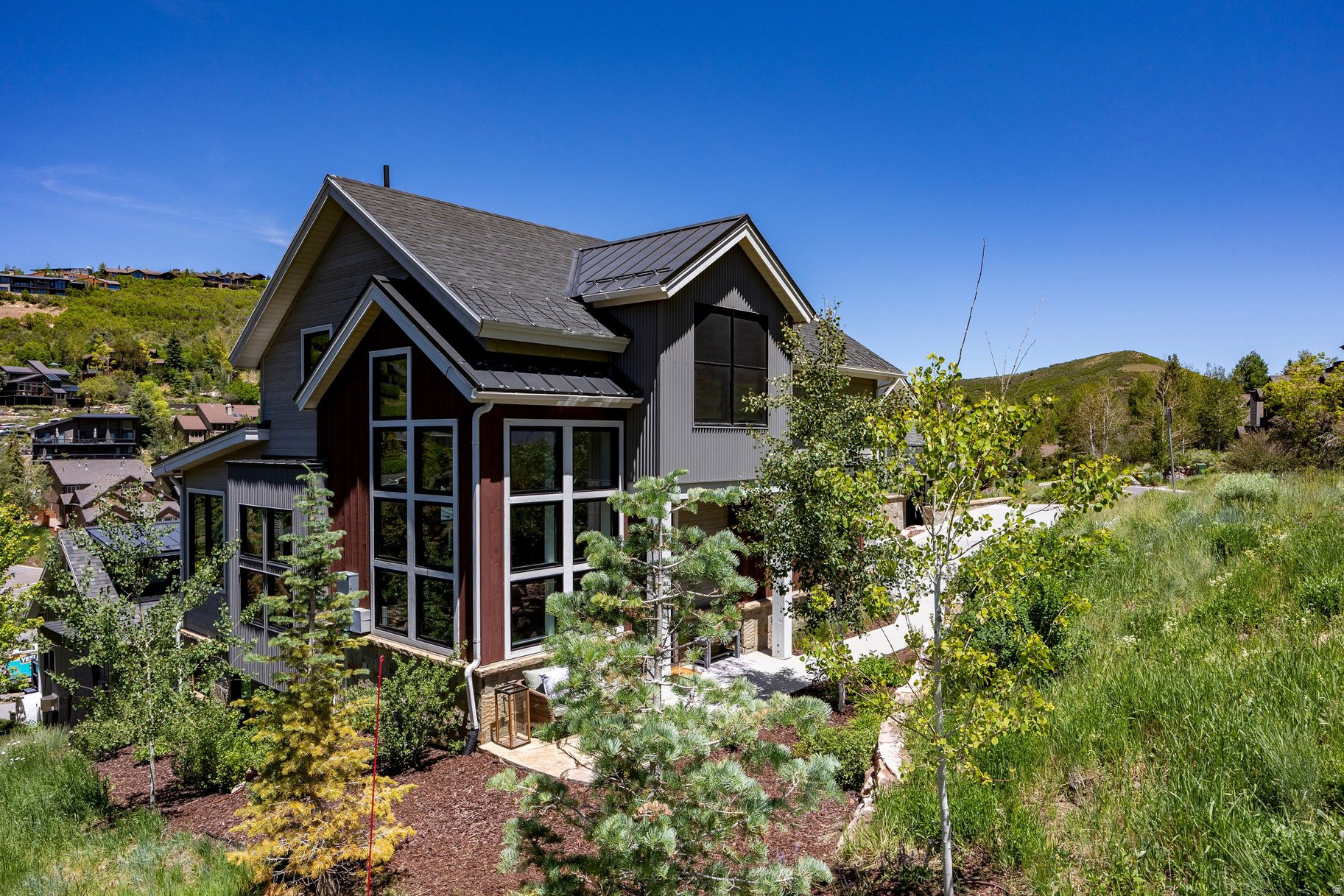 It is simply hard to find a better Park City location than the homes at Lilac Hill. Halfway between Deer Valley's Snow Park Lodge and Historic Main Street, 611 Rossie Hill is a few minutes walk either direction to all of the winter and summer time activities that make Park City so appealingregardless of the season.  This exceptional Old Town residence is adjacent to open space, offers a spacious two-car garage and ample on street parking along Rossie Hill Drive. Upon entering, a striking three-story glass-and-walnut staircase creates a dramatic focal point, framed by south-facing windows that showcase panoramic mountain views protected by Dedicated Open Space. Rich walnut flooring and thoughtfully selected designer finishes add warmth and sophistication throughout the home. The main level is filled with natural light and features a chef's kitchen, dining area, two-sided fireplace, and a living room surrounded by expansive windows. Upstairs, the primary suite serves as a private retreat, complete with its own fireplace, a spacious walk-in closet, and a luxurious bath. A second upstairs bedroom provides flexibility as a guest room or private office. Designed for both entertaining and relaxation, the lower level includes a comfortable family room with a wet bar and two additional bedrooms, offering privacy and comfort for family and guests alike. The attached two-car garage is outfitted with generous storage, boot warmers, and an EV charging station. Whether you are looking for your new primary residence, a second home, or a great vacation rental this 4 bedroom home in a fantastic Old Town location delivers.