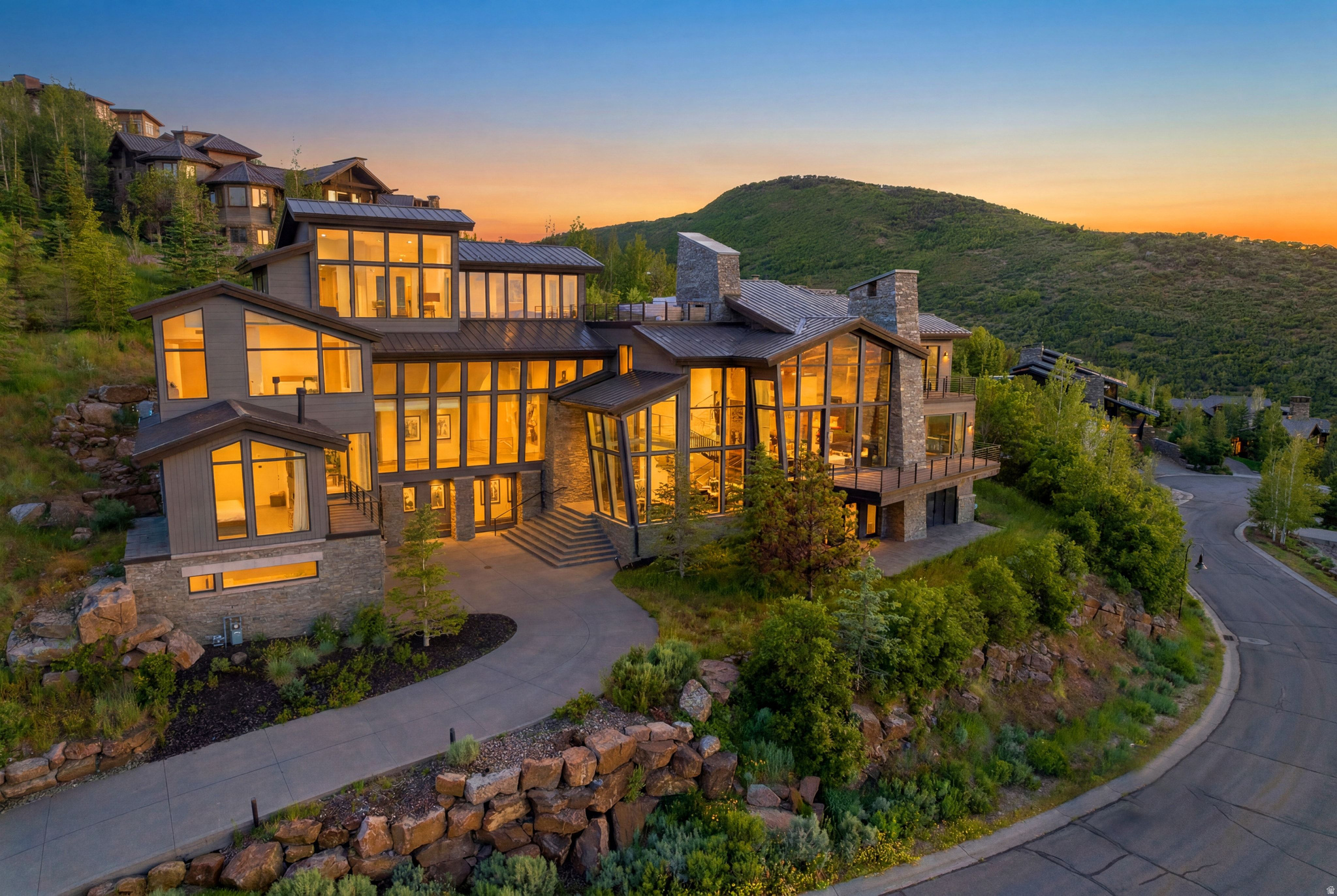 Perched high above the glistening waters of Jordanelle Reservoir this architectural triumph by Michael Upwall is more than just a home. It is an alpine sanctuary designed for those who dream in powder turns and panoramic views. With direct ski access from the Homerun trail at Deer Valley Resort your day on the slopes begins not at the base but on your own private rooftop ski deck a thrilling gateway to Deer Valley's world class terrain and the future East Village expansion. Every inch of this four level masterpiece is a testament to thoughtful artistry and craftsmanship. Exposed steel beams meet warm hardwood floors, hand rendered fireplaces glow with inviting ambiance and floor to ceiling leaning glass walls blur the lines between indoors and the breathtaking mountain landscape beyond. Whether you take the stairs or the private elevator each level reveals a new layer of luxury and innovation.  And when the final run of the day is carved the rooftop awaits a private apres ski retreat complete with a fireplace, firepit and hot tub all set against the backdrop of an endless alpine horizon. Nestled within the exclusive gated enclave of Deer Crest at Deer Valley Resort this home is more than a residence. It is a rare opportunity to own a piece of what will soon be one of the largest and most prestigious ski resorts in the world.