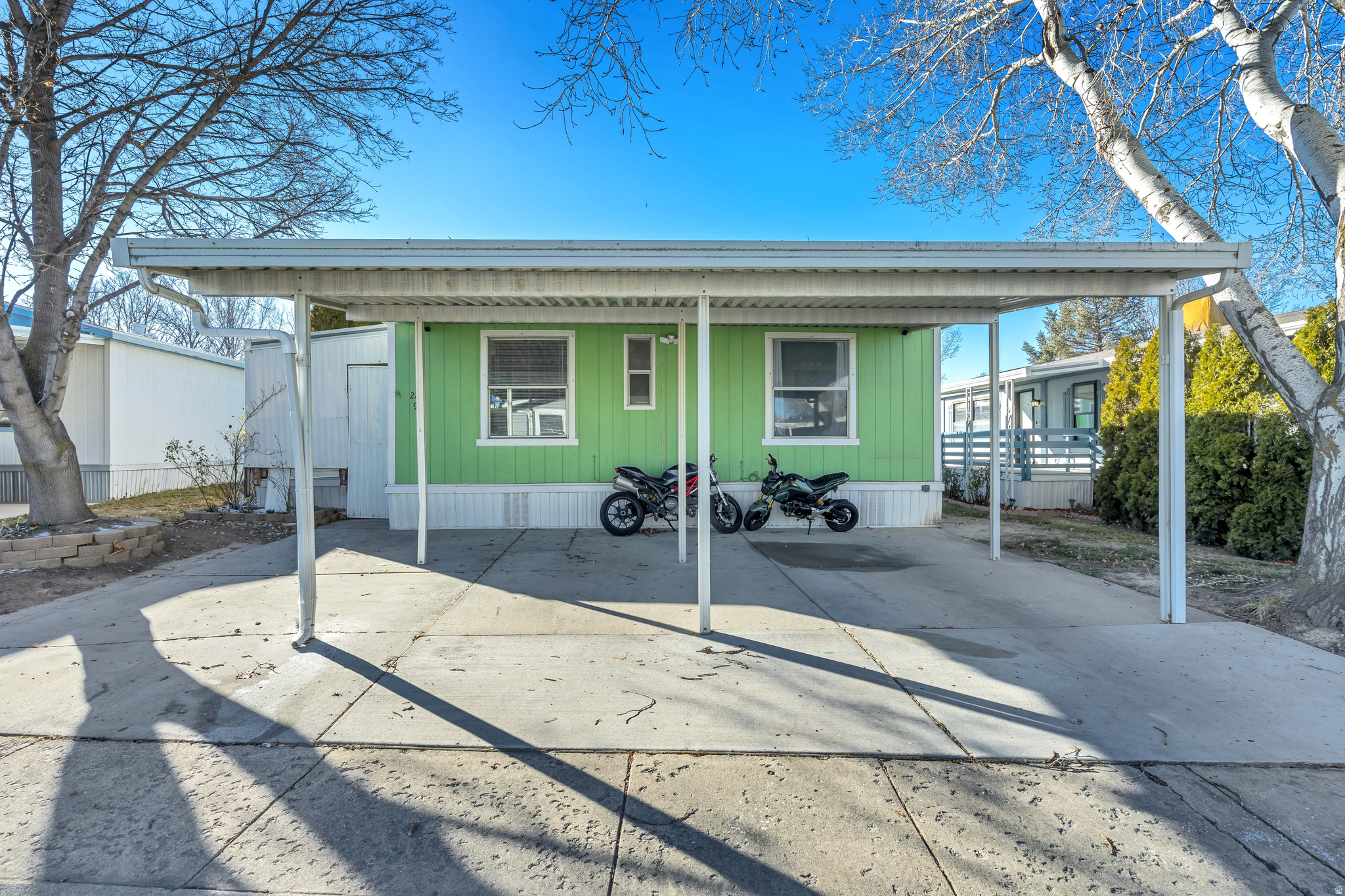 BACK ON THE MARKET! Nice double wide in a quiet park, close to I-15 and shopping. It features vaulted ceiling, tile in the kitchen and living room. Large primary bedroom and bathroom with a large tub to relax in. Newer roof. Large fenced backyard. Has coved parking for 3 cars. Furnace and AC are about 4 years old.