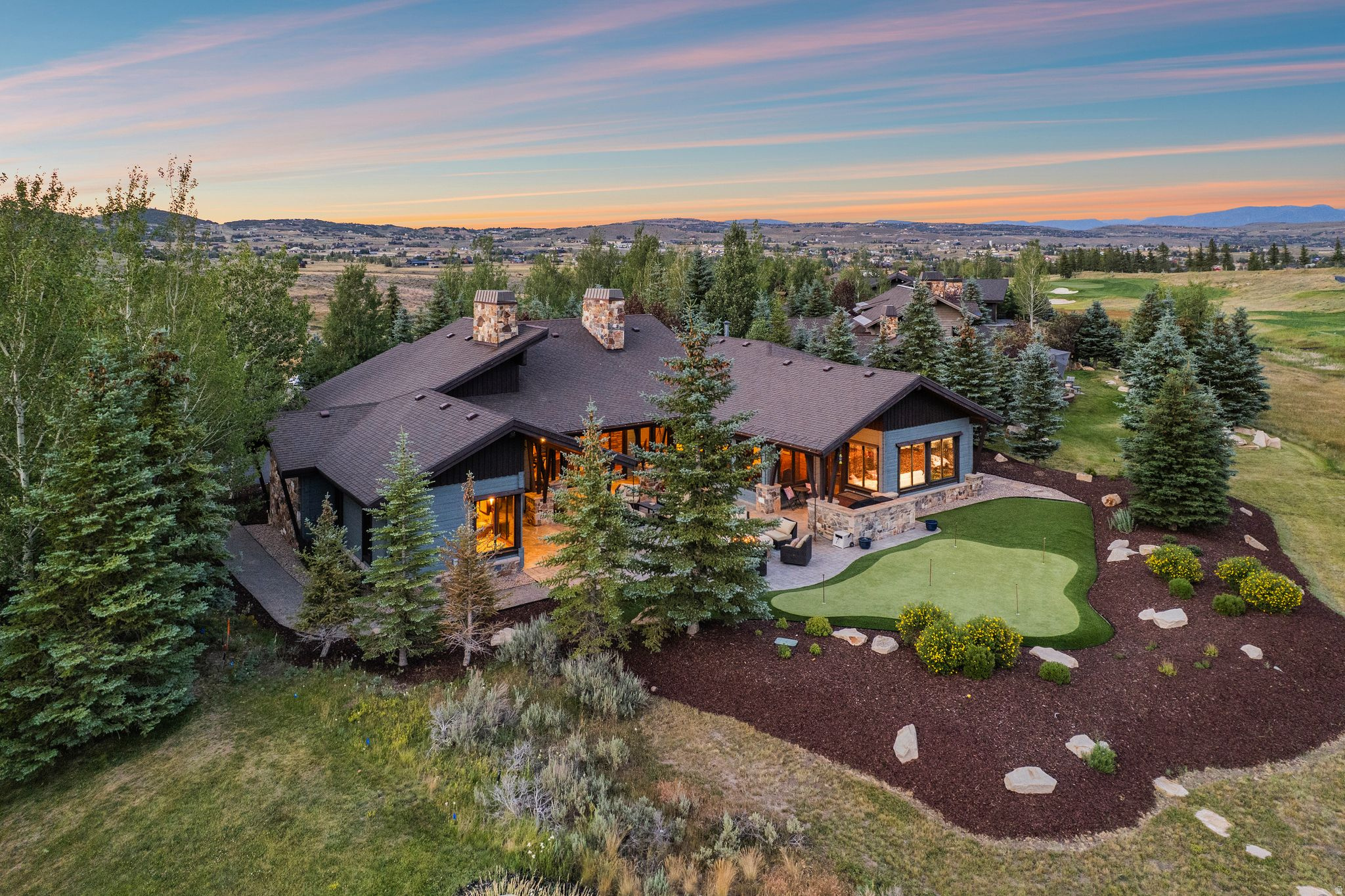 Glenwild Single Level Home with Golf Course and Mountain Views! Experience rare single-level living in this beautiful south-facing home located in the exclusive Glenwild community. Situated along the third hole of the prestigious Glenwild Golf Club--ranked the #1 golf course in Utah by Golf Digest--this impeccably maintained residence offers a rare combination of privacy, luxury, and breathtaking views.  The thoughtfully designed floor plan features four bedrooms plus an office, a spacious great room, and a separate living room, creating the perfect balance of everyday comfort and elegant entertaining. The private primary suite is thoughtfully separated from the additional bedrooms, offering a peaceful retreat with enhanced privacy. Expansive windows showcase picturesque golf course views in the foreground with the dramatic ski mountains of the Wasatch Back as the backdrop.  Outdoor living is truly exceptional, with a private entertaining area featuring a built-in barbecue grill, expansive paver patio, and private putting green--perfect for relaxing with family and friends while enjoying Park City's spectacular surroundings. This exceptional Glenwild residence offers the ideal blend of mountain living, golf course lifestyle, and effortless single-level convenience.