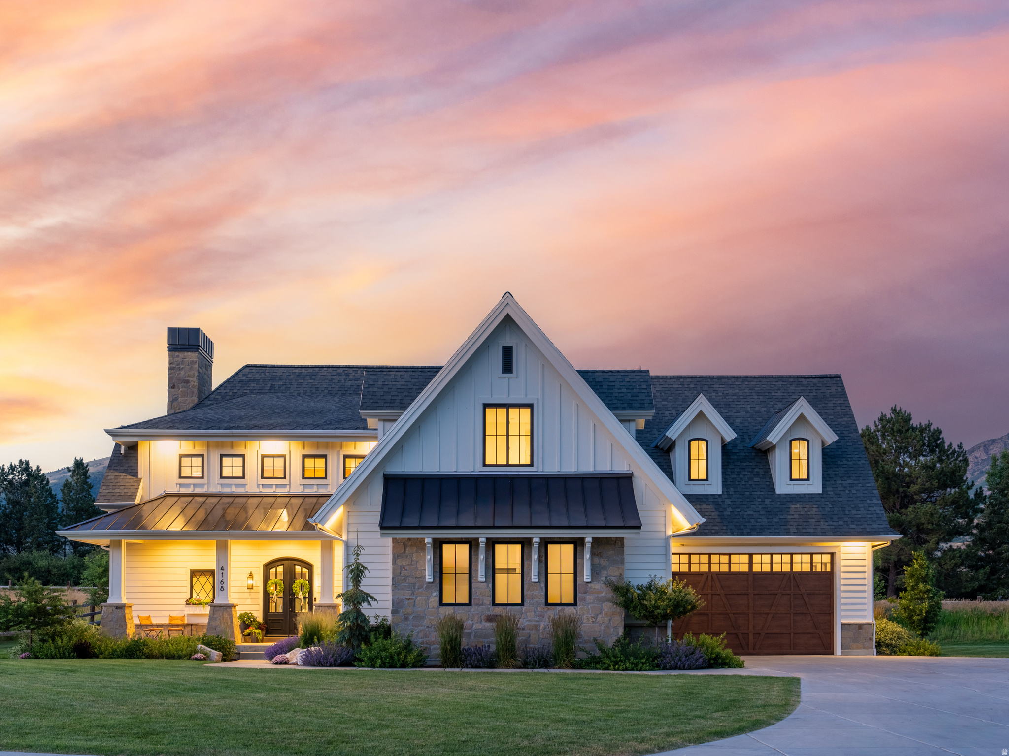 This custom 5-bedroom, 5-bathroom home offers 6,390 square feet of living space on just under one acre in Elk Ridge Estates-an exclusive three-member HOA located in Liberty on the northwest farmlands of Ogden Valley. As the first property ever made available to the public in this private neighborhood, it features unobstructed mountain views and borders protected open space. The setting provides a rare blend of peaceful country living with convenient access to urban amenities. I-15 and downtown Ogden are approximately twenty minutes away, while Salt Lake City International Airport is about an hour to the south. Year-round recreation is close at hand, with North Fork Park, Powder Mountain, and Pineview Reservoir all just minutes from the front door. Inside, a vaulted great room makes a striking statement with exposed timbers, a full-height stone hearth, and both wood-burning and gas fireplaces. The chef-caliber kitchen combines white cabinetry, statement tile, professional-grade appliances, designer lighting, and premium plumbing fixtures around an island with seating for four. The main-level primary suite includes vaulted ceilings, abundant natural light, a spa-inspired bathroom, and a spacious walk-in closet. A half bath on this level also incorporates a dog-wash station. Upstairs, three additional bedrooms are joined by a flexible bonus room and a dedicated office. The lower level offers one bedroom and one full bathroom. Additional practical features throughout the home include an oversized pantry, a full mudroom, a built-in desk nook, extensive storage, and a secure vaulted safe. The landscaping enhances the property with flat lawn areas, while unbroken views of the Wasatch Mountains stretch beyond the home's boundaries. Elk Ridge Estates protects the surrounding open space, ensuring lasting privacy and a remarkable sense of place. All property information, boundaries, and documents to be verified by the buyer.