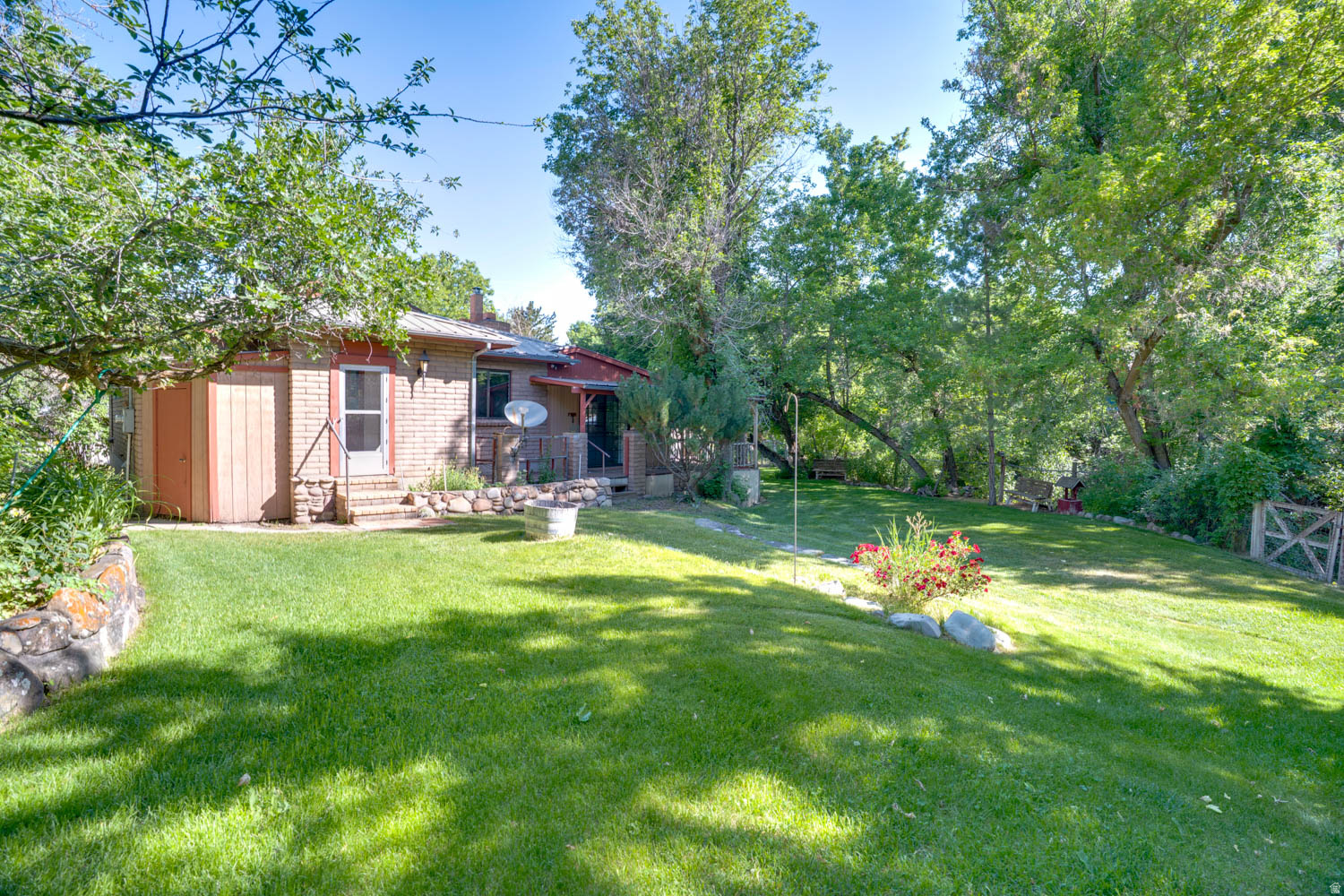 Great rambler situated on a generous 0.50 acre lot in Storm Haven. Seasonal creek runs through the back of the property. Private yard surrounded and shaded by mature trees. Many outbuildings including a chicken coop and detached 2 car garage. Home offers two bedrooms, living room open to the dining area and kitchen. Water share included.  Escape to the peaceful beauty of the Heber Valley with this great home located a few minutes from all the shopping, dining, schools and recreation that Heber City has to offer. Quick access to HWY 40 with Strawberry reservoir just 20 minutes away, endless year-round recreating with fishing, boating, ATV's, camping and snowmobiling! Buyer to verify all.