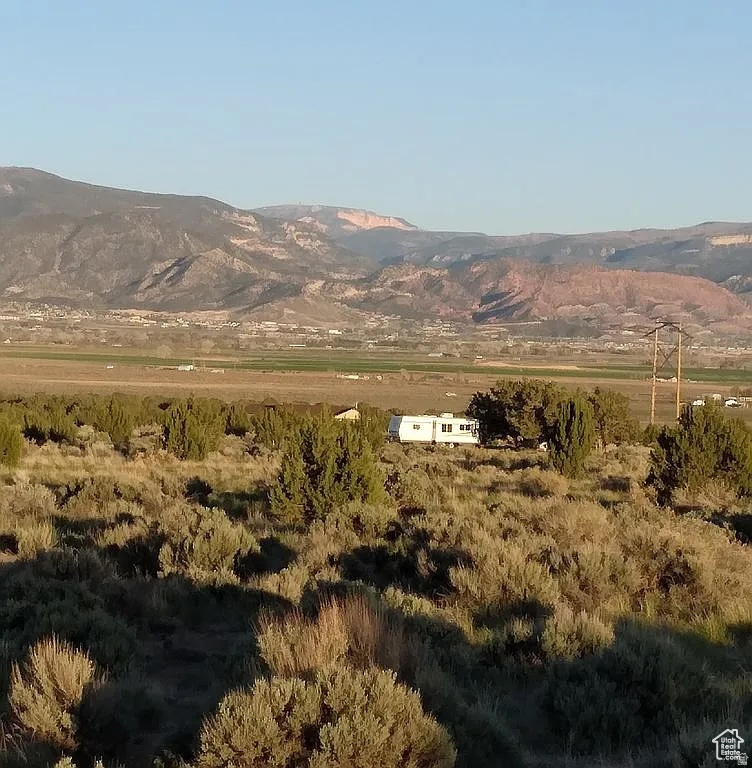 100K Price Reduction! Seller Is Very Very Motivated! 100% Flat buildable estate lot for Single Family Home + Guest house + ADU + Garage + Barn The lot has power and culinary water connections on site, 1 acre foot water share to be included with more water shares available, Fire hydrant on the property. Seller finance with 25% down possible