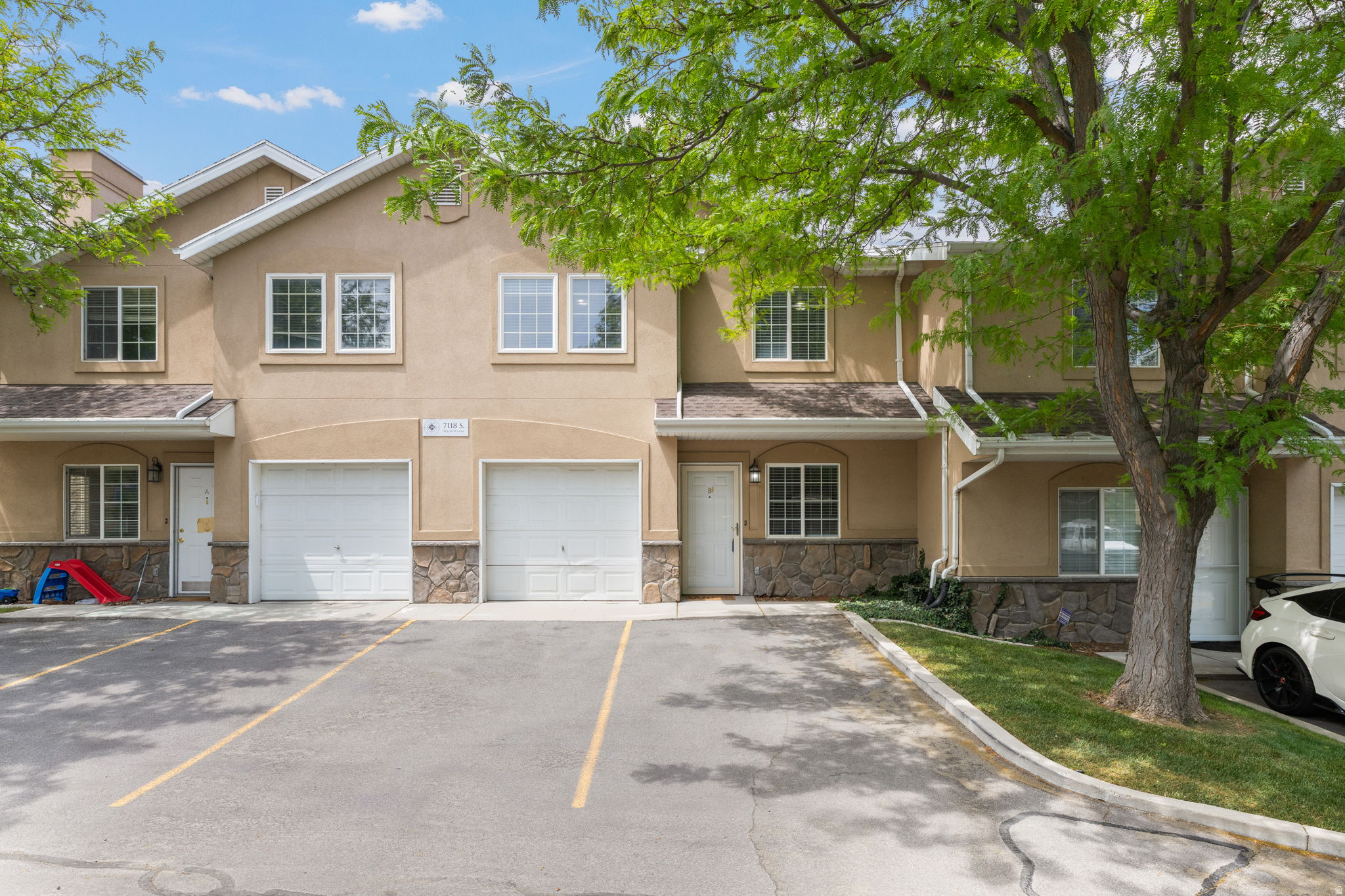 Tucked inside a gated community near the border of West Jordan and Midvale, this well-maintained townhome offers the perfect blend of convenience, comfort, and low-maintenance living. Ideally located just minutes from freeway access, Topgolf, RiverWalk's vibrant dining and retail district, Bingham Junction Park, and the growing Bingham Junction corridor, the location makes commuting and enjoying the area effortless. The home is also just moments from the Jordan River Trail, offering miles of scenic walking and biking paths for those who enjoy an active lifestyle and easy access to the outdoors.  Inside, you'll find a bright and functional layout with generous natural light, spacious bedrooms, and a kitchen that flows seamlessly into the main living areas, creating an inviting space for both relaxing and entertaining. The home features 3 well-sized bedrooms, 2 full bathrooms, attached 1-car garage, two designated parking spaces, and in-unit laundry for added convenience. There is also the potential to add an electric vehicle charger in the garage.  The community is designed for easy living and offers playgrounds, basketball courts, pavilion areas, and beautifully maintained grounds, allowing you to spend more time enjoying life and less time worrying about maintenance. Families will also appreciate the nearby elementary school and the new pedestrian bridge currently being built, designed to provide safer and more convenient access for children walking or biking to school. Whether you're looking for a comfortable place to call home or seeking a simplified lifestyle without sacrificing location, this townhome delivers exceptional value in one of the valley's most convenient areas.