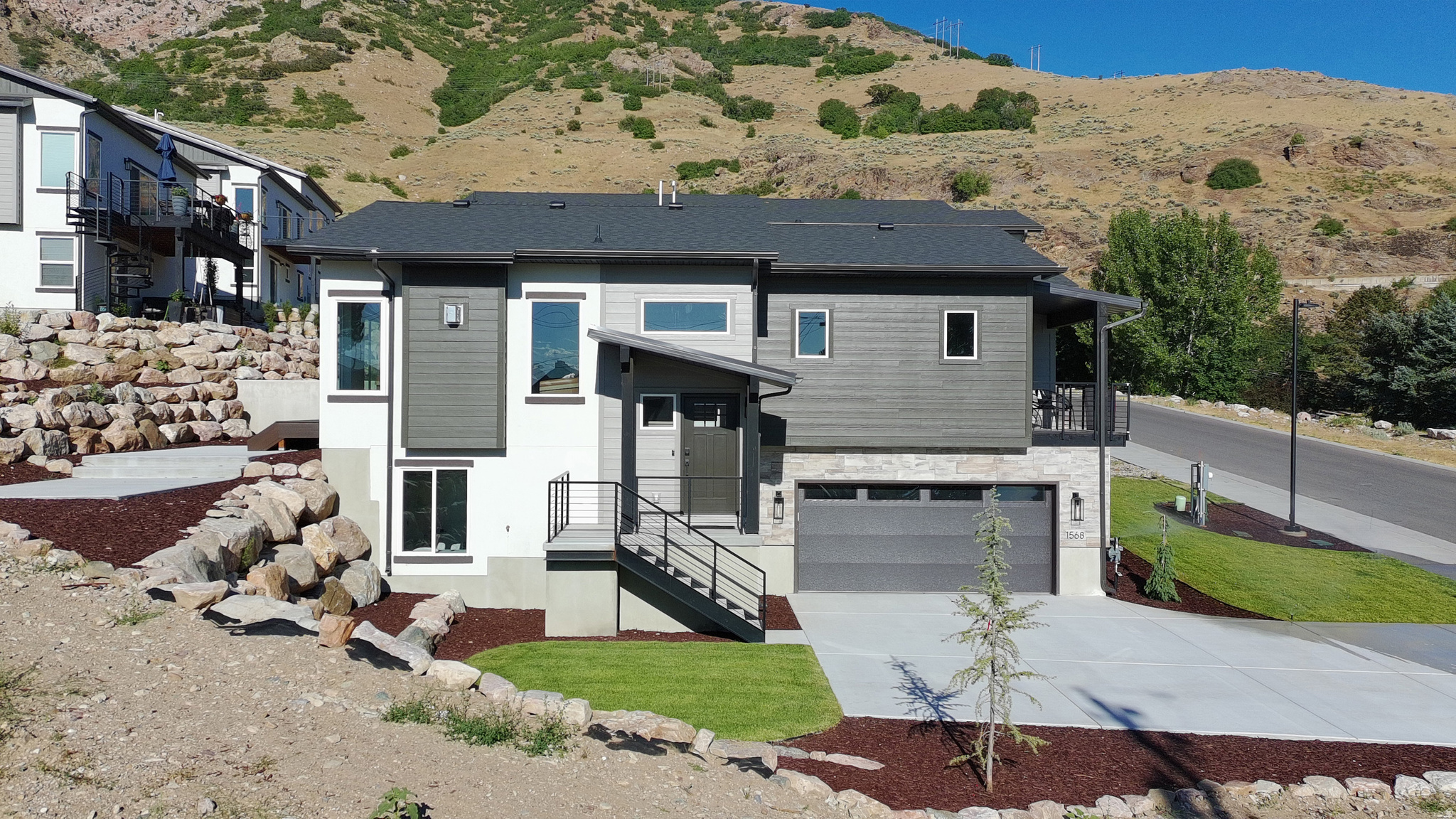 Brand new and ready for occupancy! Live high on the east bench in Ogden and enjoy this home nestled on Ogden's picturesque east bench offering the perfect blend of modern luxury and outdoor adventure. This home is custom built to boast breathtaking panoramic views and provide direct access to scenic hiking trails, inviting you to embrace the beauty of nature right outside your doorstep. Upgrades and views everywhere you look! The sleek kitchen is a chef's delight, equipped with premium appliances, stylish cabinetry and ample counter space flowing into the the main living area with tons of natural light and a bonus deck with expansive mountain and city views. A walk-in closet in the master with a separate soaking tub and balcony. Absolutely must see. Ask about special lender incentives! Luxury paired home style.