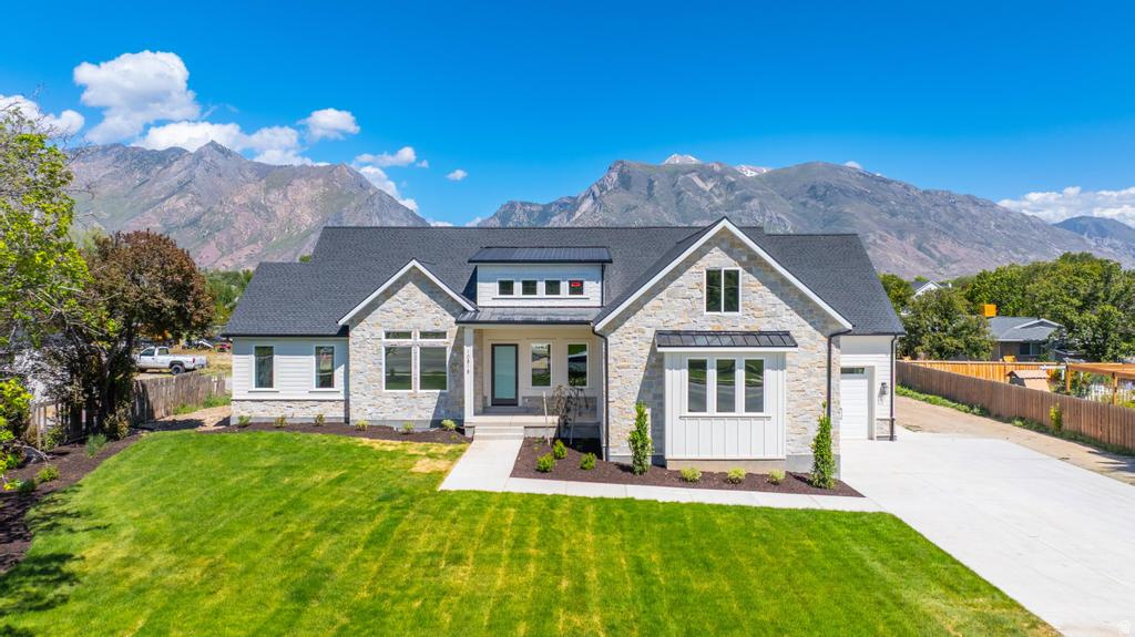 Nestled on a full acre in one of Highland's most coveted settings, this exceptional custom residence showcases breathtaking mountain views, soaring ceilings, and walls of windows that flood the home with natural light. Thoughtfully designed with timeless elegance and modern sophistication, the open-concept layout centers around a stunning gourmet kitchen featuring custom cabinetry, an oversized island, walk-in pantry, and designer finishes, all flowing seamlessly into the grand great room anchored by a dramatic floor-to-ceiling stone fireplace.  Designed for both refined entertaining and everyday living, the home offers 5 spacious bedrooms, a dedicated exercise room, formal living room, family rooms on all three levels, and exceptional storage throughout. The finished lower level is equally impressive, featuring a full kitchen and expansive gathering spaces ideal for hosting guests, extended family, or multi-generational living. The luxurious primary suite serves as a private retreat with a spa-inspired bath, freestanding soaking tub, and oversized walk-in shower. Enjoy a 50 amp car charging outlet in garage.  Step outside to the covered deck and take in the stunning mountain backdrop, while the expansive backyard offers a rare opportunity to create the outdoor oasis of your dreams-whether that includes a resort-style pool, sport court, gardens, additional garage space, or unforgettable entertaining areas. One year builder warranty!