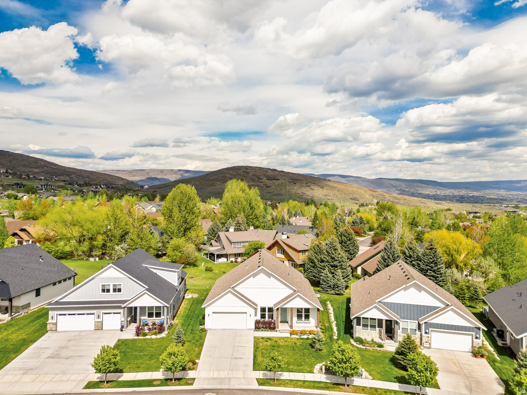 Situated amid the pastoral beauty of Midway, this beautifully updated 3-bedroom, 3-bathroom home in the sought-after Scotch Fields neighborhood offers comfortable single-level living surrounded by breathtaking Alpine scenery. Located just minutes from world-class recreation, including blue-ribbon fly fishing, championship golf, celebrated skiing in Park City, Wasatch State Park, and endless water sports, this home blends mountain lifestyle with everyday convenience.  The thoughtfully designed main level features an open great room with a gorgeous updated kitchen complete with a large island that seats six, seamlessly connecting to the spacious living and dining areas. Large windows invite in natural light and frame the surrounding views, while the back patio provides the perfect setting for grilling, relaxing, and enjoying Midway's fresh mountain air.  The spacious primary suite offers a peaceful retreat with a soaking tub, double vanity, separate shower, and large walk-in closet. Two additional bedroom suites provide comfort and privacy for family or guests. A laundry room and attached 2-car garage complete the home.  HOA community perks include pickleball courts, internet, and landscaping. Well-maintained and move-in ready, 1258 Canyon View Road offers an exceptional opportunity to enjoy the charm, recreation, and natural beauty that make Midway one of Utah's most beloved mountain communities.