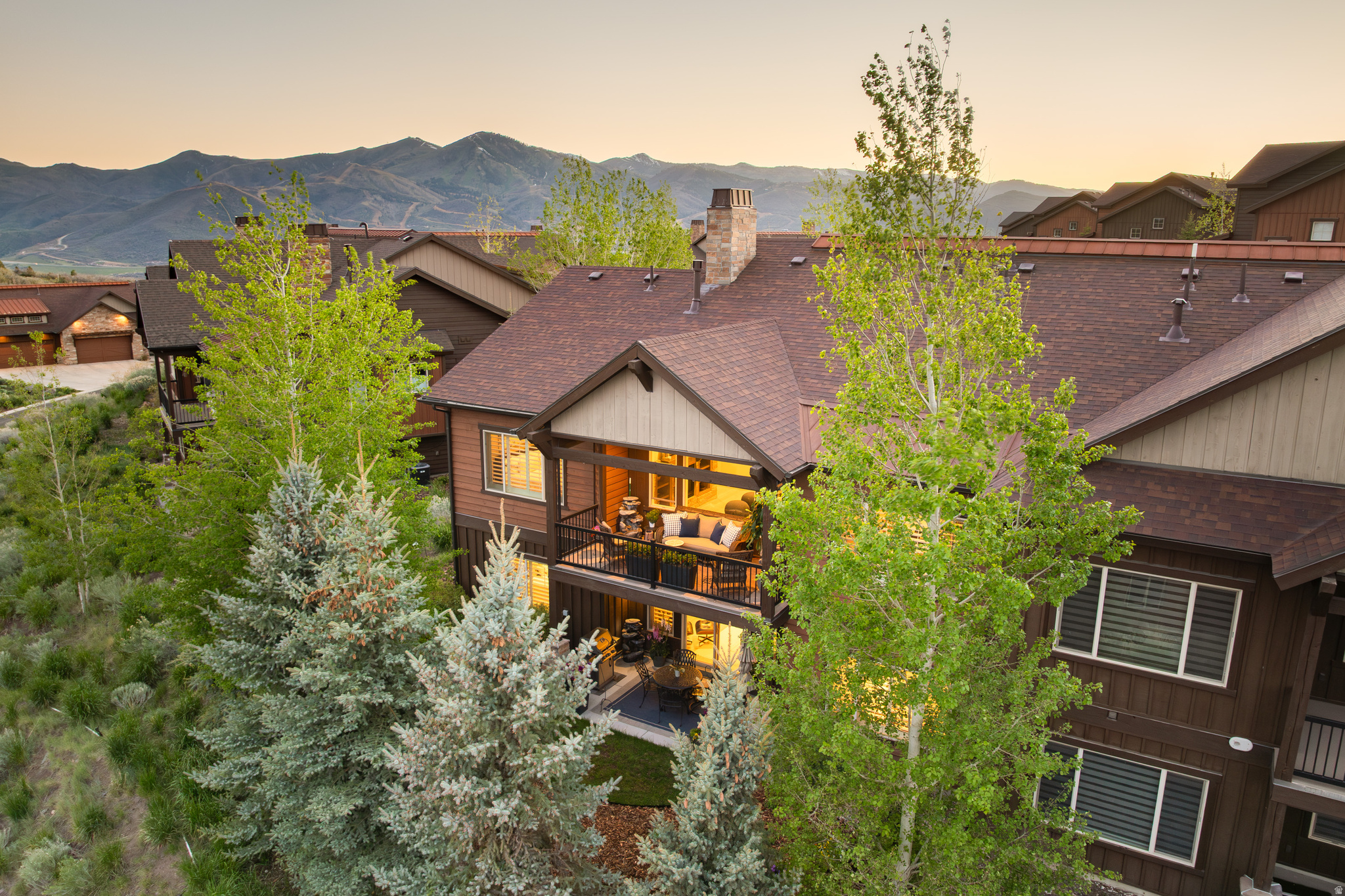 Pristine, bright, and spacious, this Rustler at Hideout residence offers easy access to the best of the greater Park City lifestyle. Built in 2017, the home features a thoughtful open floor plan with a main level primary suite, abundant natural light, and quality finishes including hardwood floors and recently updated kitchen and baths with quartzite countertops. As a twin home corner unit, it enjoys added privacy along with a light, expansive feel throughout.  The open kitchen, dining, and living area is designed for both comfortable everyday living and entertaining, with a large glass slider opening to a private deck with mountain views and seamless indoor-outdoor flow. Mature landscaping, gardens, and a private patio create additional inviting spaces to relax and unwind.  With 3 bedrooms, 3 bathrooms, two separate living areas, and a flex gym/theater room, the home offers plenty of flexibility for guests, entertaining, or full-time living. A 2-car garage, short, flat driveway, and quiet cul-de-sac location add to the privacy and convenience. Located just minutes from Deer Valley East Village, Jordanelle Reservoir, hiking and biking trails, and kayak and paddleboard launch, this home is equally well suited as a full-time residence or a four-season lock-and-leave mountain getaway.