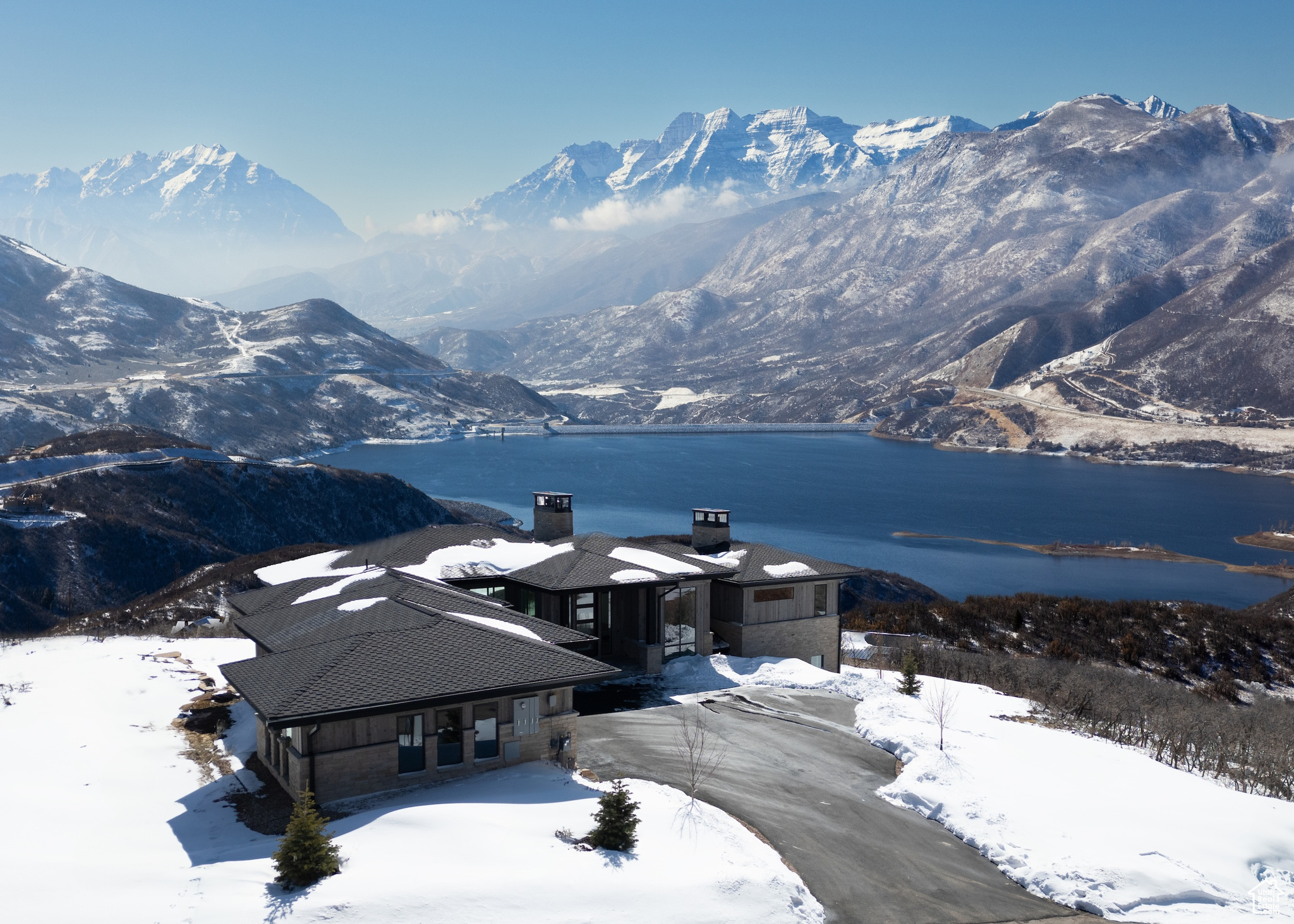Discover unbeatable panoramic views of Deer Valley, the Jordanelle Reservoir, and Mount Timpanogos in this home designed by Otto-Walker Architects and brought to life with the distinguished craftsmanship of Germania Construction. Perched on a 0.60-acre lot in the community of Golden Eagle, the setting promises serene living and spectacular scenery year-round, with the benefit of world-class skiing and vibrant entertainment 10 miles away in historic Park City, Utah. The interior of the home celebrates the breathtaking views from nearly every corner of this residence. The great room, with vaulted ceilings and expansive windows, fills the home with natural light and maximizes the views. The interior design, finishes, custom cabinetry, and fixtures selections are by Teri Nelson and Brittney Burns Dubay The kitchen is a chef's delight, boasting top-of-the-line appliances and a large island for cooking and entertaining. The kitchen leads into a cozy hearth room, perfect for quiet mornings or intimate gatherings. The main-level primary suite is a haven of relaxation, complete with a private balcony and an ensuite that includes a soaking tub with a view. An office, laundry, and powder complete the main level. The lower level is designed for fun and relaxation, with a family room with a fireplace, wet bar, billiards, and access to an outdoor covered patio. The three additional bedroom suites ensure comfort and privacy for everyone. A powder bath & large laundry room complete this level. With the new Mayflower base area and the Jordanelle Reservoir mere minutes away, hundreds of miles of trails in your backyard, and a plethora of outdoor attractions nearby, nature recreation has never been so easy.  The proximity to the best skiing in the west, the entertainment of Park City, & the Salt Lake Int'l Airport make the location unbeatable
