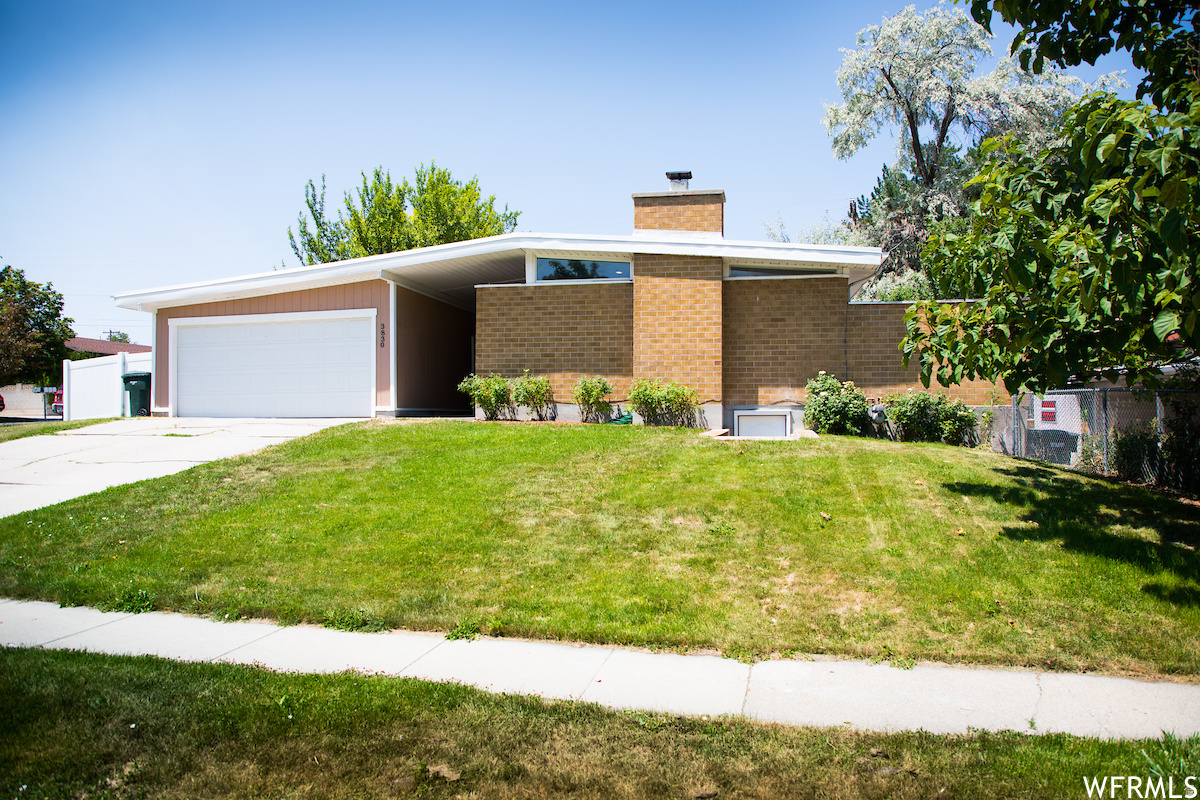 Discover peaceful evenings in this remarkable single-family home nestled in a well kept West Valley neighborhood. This residence offers the perfect blend of comfort, style and a hint of the mod look. It has abundant natural lighting and a private backyard-oasis where you'll feel right at home from the moment you step inside. Ready for 2 Kitchens- some plumbing is there now for a future basement kitchen, perfect potential apartment, 5 spacious bedrooms and 3 Full bathrooms, including a beautiful primary en-suite master bedroom; this home is designed with both functionality and large gatherings in mind. The kitchen is a chef's dream, featuring granite countertops, a charming serving bar island, and a double. From here, step out onto a covered patio right off the kitchen dining area and a retreat for morning relaxation and evening gatherings. With remodeled kitchen and baths, the home exudes a fresh, welcoming ambiance. The main floor and fully finished basement are enhanced with new excellent, durable and stylish design. Whether you're enjoying the warmth of the living areas or the peaceful retreat of your backyard, every detail of this home has been thoughtfully crafted to elevate your lifestyle. Roof is less than 5 years old per the previous owners. Contact owner (Drew) for questions about showing and availability.  The pictures shown were taken in 2020. They are very similar to what is there now.