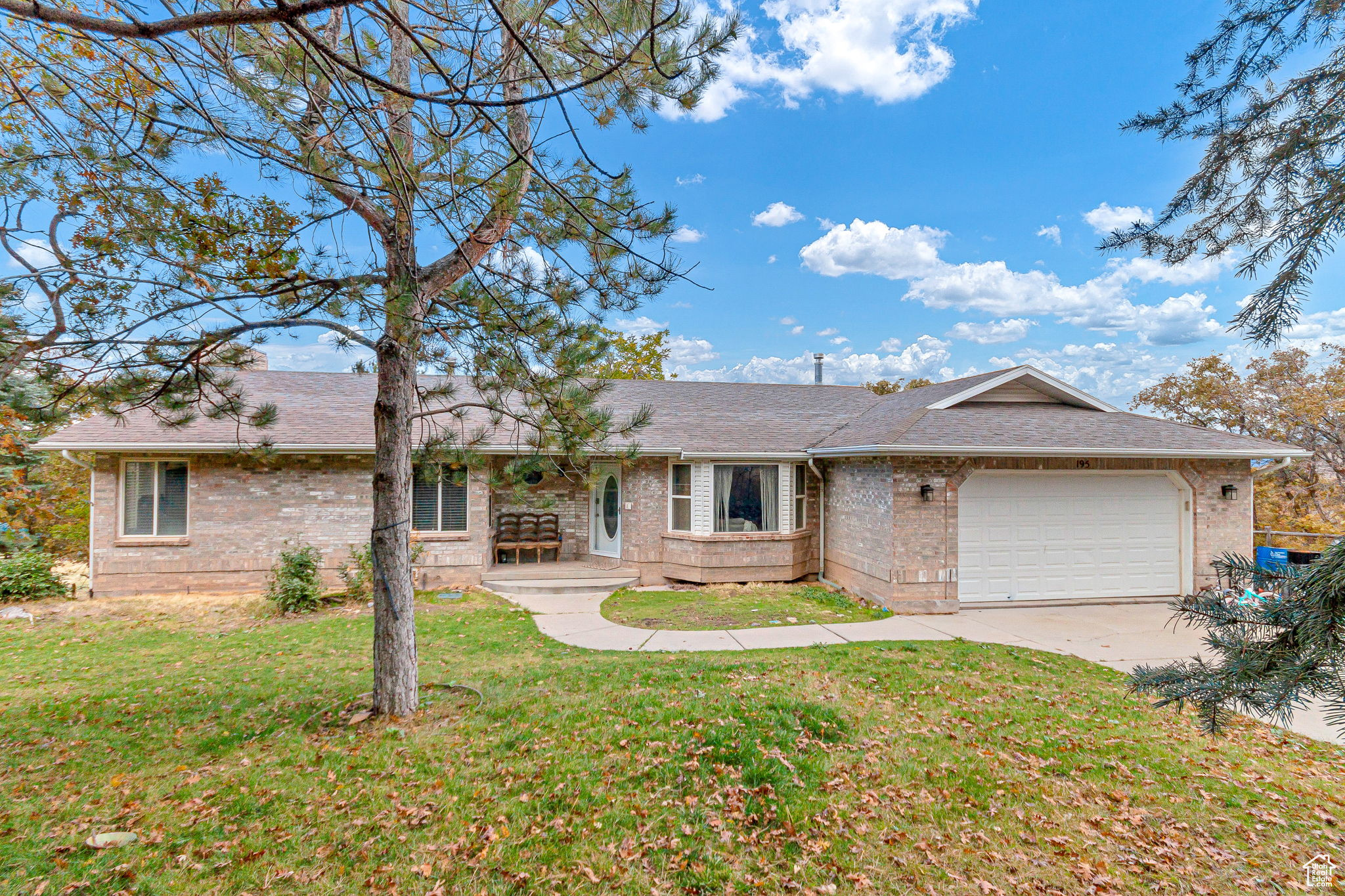 Nestled on just over an acre of beautifully wooded land, this timeless brick home offers the perfect blend of privacy, nature, and views. Mature pine trees and native scrub oak surround the property, creating a natural sanctuary that feels miles away-yet sits within minutes of town conveniences.  Step outside to sweeping valley views below and majestic mountain vistas above, all framed by the serene setting of your own secluded hillside retreat. The expansive lot provides ample space for gardens, outdoor living, or simply soaking in the peace and quiet that Woodland Hills is known for.