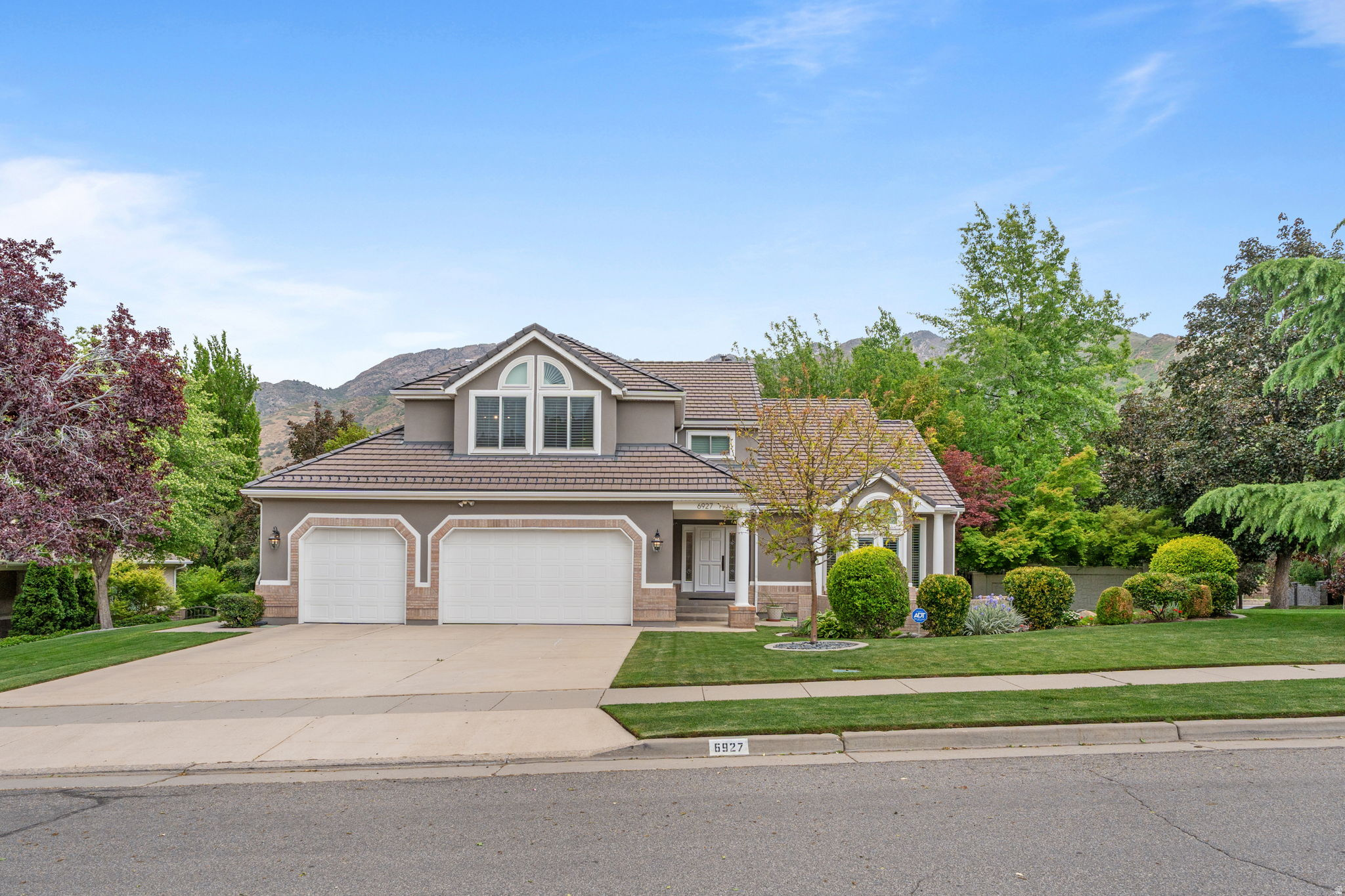 This is your chance to live in one of the most unique homes in one of the area's most established and sought after neighborhoods...Old Mill Estates. This incredible home features a private backyard resort unlike anything else in the community. The prime location, near the base of Big Cottonwood Canyon, offers quick access to world class ski resorts, hiking and biking trails. Freeway access is only two minutes away, making downtown, shopping, dining, and the airport easily accessible. You will appreciate the exceptional care and thoughtful design put into this home with both relaxation and entertaining in mind. It offers a refined blend of luxury, and intentional craftsmanship throughout. As you arrive, notice the elegant bartile roof equipped with an integrated heating system to minimize winter ice and snow buildup. The front door is custom-crafted from Pella and opens into an inviting living room where soaring ceilings, hardwood floors, recessed lighting and an abundance of natural light creates a warm, open feel in the living room. The adjacent elegant dining room showcases a gorgeous coffered ceiling, while the large kitchen is appointed with rich mahogany cabinets with integrated appliances, including Thermador double ovens.  A main floor, private mother-in-law suite with its own bathroom and separate outdoor entrance provides excellent flexibility for guests. The kitchen flows into a cozy family room featuring surround sound, a gas fireplace, and the convenience of remote to control the temperature. The home is further enhanced with all-new top of the line Andersen windows and exterior doors throughout and comes with a  warranty.The lower level features a pool room with surround sound and designed specifically for a state of the art Diamond pool table with a premium Littman lamp. Both were professionally installed by the same Las Vegas specialists who service tables for the Vegas International tournament. This space shares a lounge area with additional surround sound and a large wall TV, creating an ideal setting for hosting and relaxation. Around the corner, a beautifully crafted cherry wood library offers great space for a study. The walk out basement opens up to a stunning backyard oasis that feels like a luxurious private resort, complete with custom-cut stone patios and walkways installed by professional masons.An exquisite, grand waterfall feature serves as the centerpiece and is equipped with a remote control system for effortless operation, along with a pond vacuum included for easy maintenance. Integrated landscape lighting enhances the entire setting, creating a calm, serene ambiance in the evenings. The entire landscape is surrounded by mature Japanese maples, magnolias, and a stately pin oak. The combination of flowing water, layered canopy, and gentle canyon breezes naturally keeps the outdoor spaces noticeably cooler and comfortable even during peak summer days. This home boasts three decks all made of Trex. An Arctic brand saltwater swim spa, tucked away in a private, secluded setting comes with a hydraulic lift cover, sits on custom deck made of Trex and includes stairs for easy access. A detached storage shed, with stucco exterior to match the home, is outfitted with lights, outlets, an insulated ceiling and provides additional functional space for storage or hobbies.The backyard is fully enclosed with a faux stone privacy fence, reinforcing both seclusion and the resort-like atmosphere.  This home has so many unique features...itis truly in a league of its own!  Square footage figures are provided as a courtesy estimate only and were obtained from county records.  Buyer is advised to obtain an independent measurement.