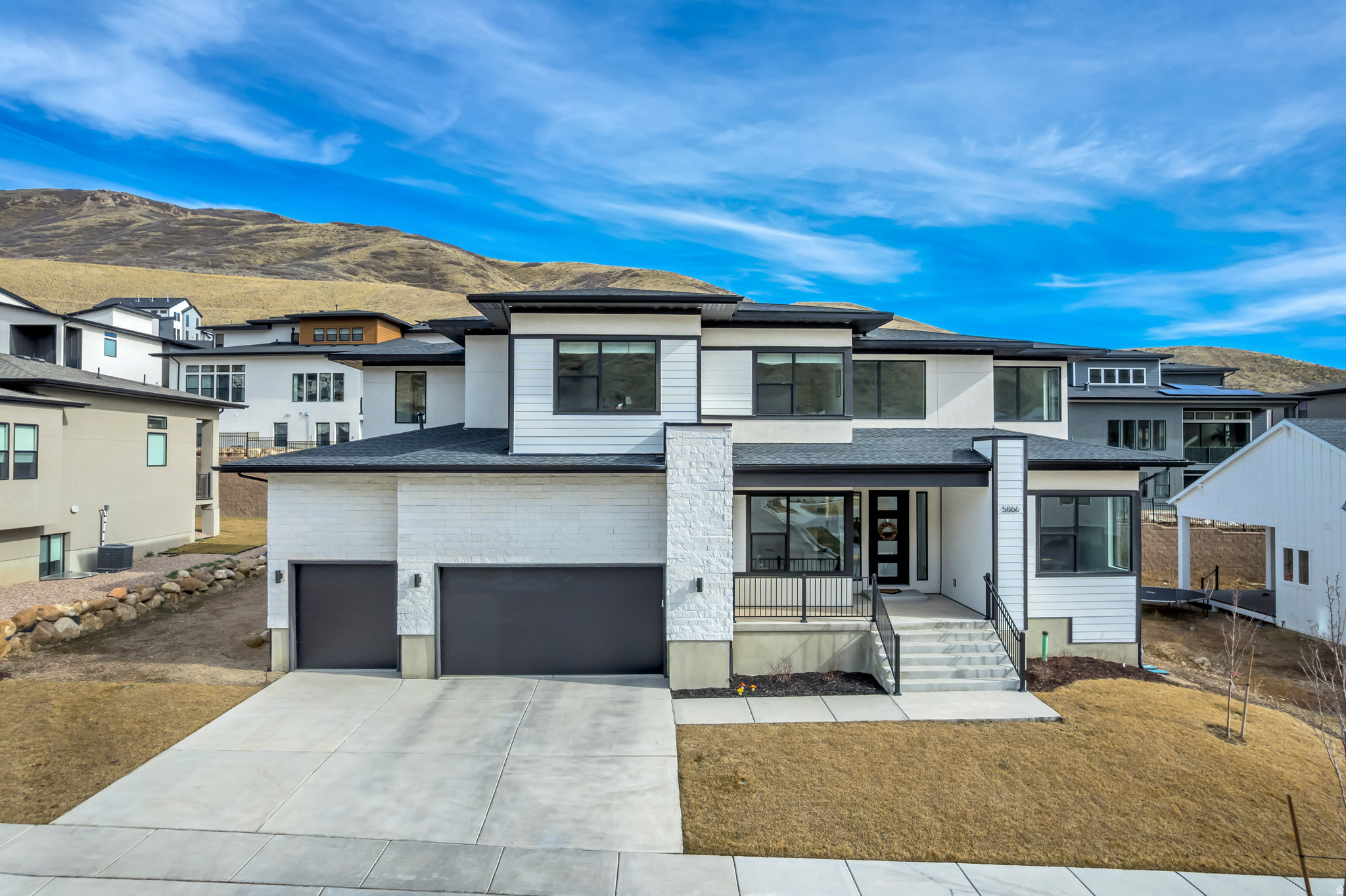 Welcome to the beautiful Canyon Point neighborhood nestled in the desirable Traverse Mountain area of Lehi! This luxurious home built by Toll Brothers effortlessly blends form and function with dramatic high ceilings and high-end finishings in a spacious, open floor plan with ample storage. The centerpiece of the property is the kitchen, featuring solid maple wood cabinetry and stainless steel JennAir appliances (induction cooktop, convection oven, microwave oven). The upgraded, oversized kitchen island is perfect for home cook and entertainer alike with stylish waterfall edges, additional cabinetry, and abundant countertop space. Natural light abounds throughout the home, from the spacious entryway to the large primary suite, both of which feature high ceilings. In addition, the primary suite has custom-designed closet cabinetry and an extra set of laundry hookups for ultimate convenience. The large sliding glass doors in the great room lead to a covered deck and a sizable, flat yard, ideal for making the most of all areas of this home!!