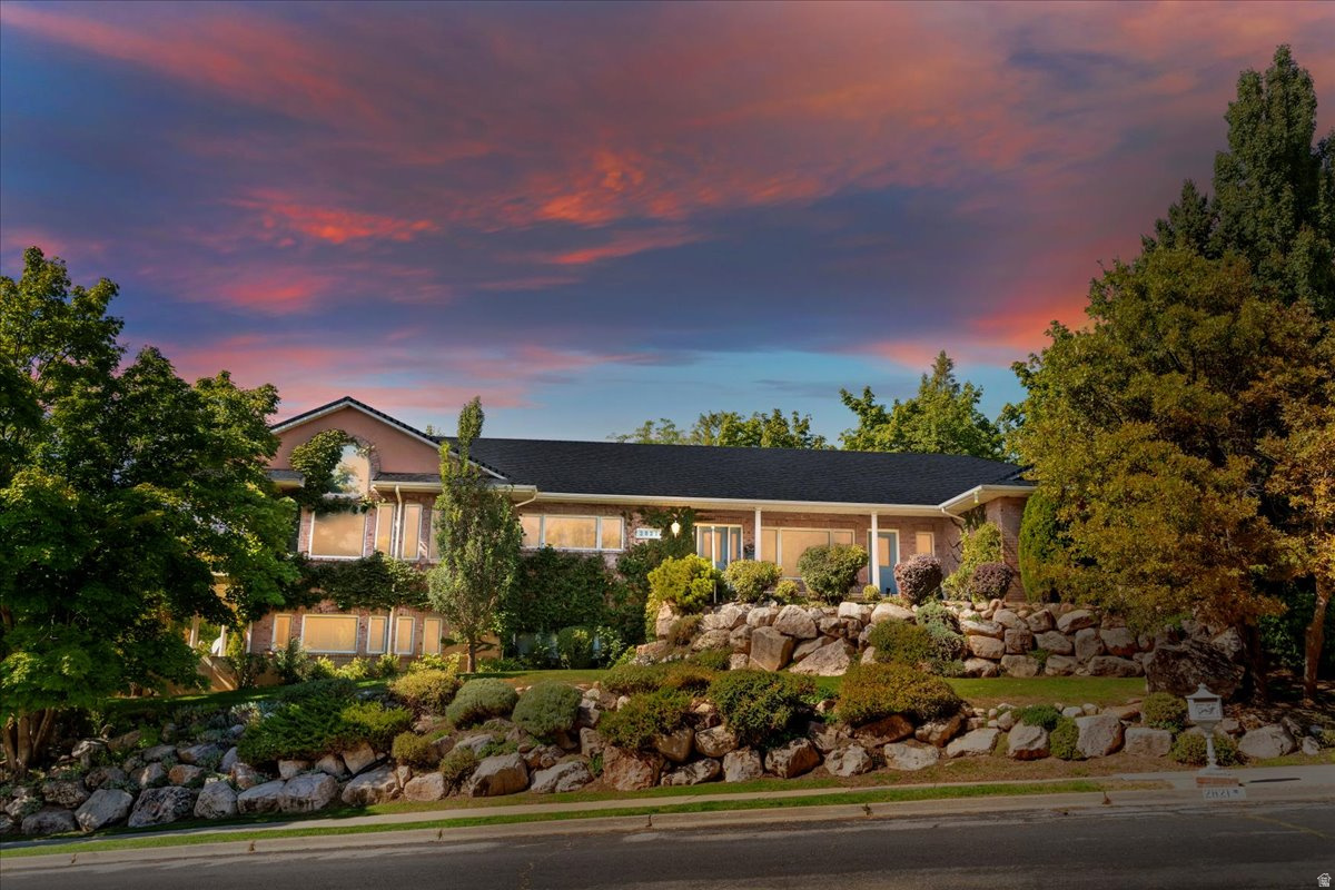 Don't miss this charming French Country home that blends rustic farmhouse warmth with refined elegance. This one-owner home was built with attention to detail, features a custom floor plan and sits on a .44-acre lot. Highlights include hardwood floors, extra cabinetry, a walk-in pantry, Thermador professional oven, subzero fridge in kitchen, vaulted ceilings, two gas plumbed fireplaces, and large windows showcasing mountain and valley views. Enjoy a wraparound deck above a matching patio, 2x6 construction, and updates to the roof (replaced fall 2018 with 40 year shingles), furnace (replaced 2017), tinted windows on east side of home (excluding garage window) and new double water heaters. There's space designed for a future elevator, a 38.5' x 15' workshop with outside access and plumbing for a sink, plus a workbench and storage shelves that stay. The oversized 35' x 28' garage includes ramp that is removeable and stairs to the basement. The basement is even plumbed for a future kitchen and drinking fountain.  HVAC has Aprilaire with multiple zones.  Yard has mature trees, garden spot and secondary water.