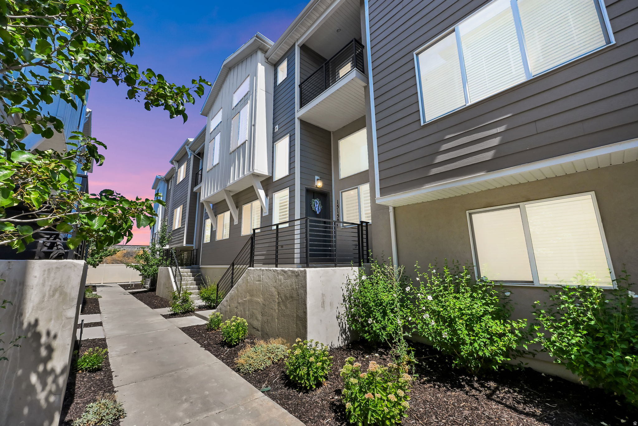 Beautifully maintained, move-in ready townhome in one of Bluffdale's most desirable communities! This bright, open-concept home features luxury LVP flooring, plantation shutters, automatic blinds for the upper windows, upgraded granite countertops throughout, stacked cabinets with crown molding, stainless steel appliances, a brand-new dishwasher, and a stunning waterfall island perfect for entertaining. Meticulously cared for, this home also includes a Ring security system with door and window sensors, a spacious primary suite with a walk-in closet and private bath, convenient upstairs laundry, and an oversized 2-car garage prewired for an EV charger. Enjoy low-maintenance living just steps from Day Ranch Park, Mountain Point Elementary, Hidden Valley Middle School, pickleball and tennis courts, a skate park, dog park, pump track, mountain bike trails, and walking paths. Conveniently located just minutes from I-15, Bangerter Highway, shopping, dining, and the future Point development, this home offers the perfect combination of style, location, and convenience. Buyer to verify all information.