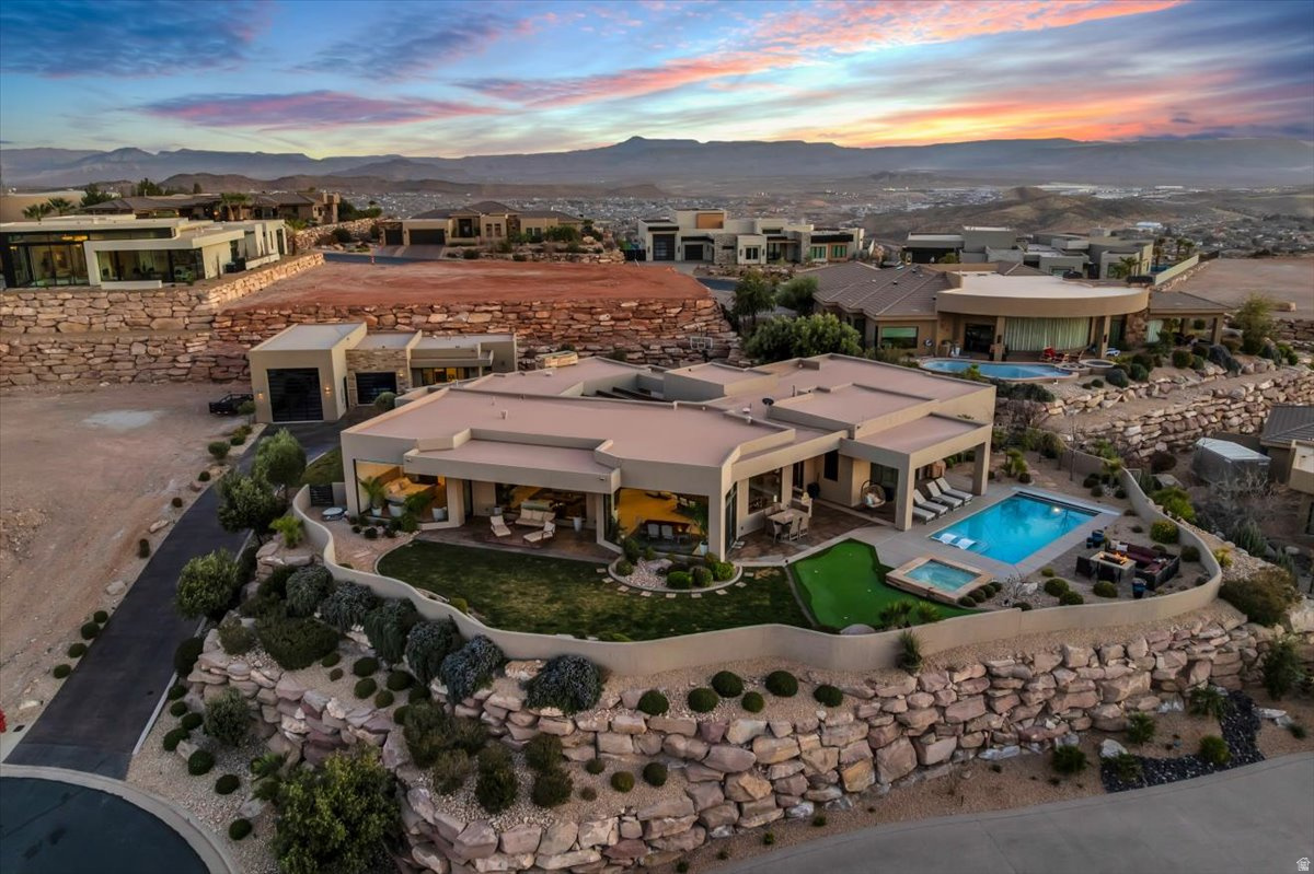 Beautiful custom home sitting at the top of the gated, prestigious Stone Cliff subdivision. This house was built around the breathtaking, unobstructed North facing views of Pine Valley, Snow Canyon, and surrounding mountains. It has an open floor plan and neutral, timeless finishes throughout. Spacious kitchen with sub-zero appliances. Each bedroom has its own bathroom and separate entrance. Detached RV+1 car garage and casita were added in 2021. This home also has a theater/game room that has sliding glass doors that opens up to the beautiful pool. Along with an exercise/bonus room this home really does have it ALL!  Furniture package available.