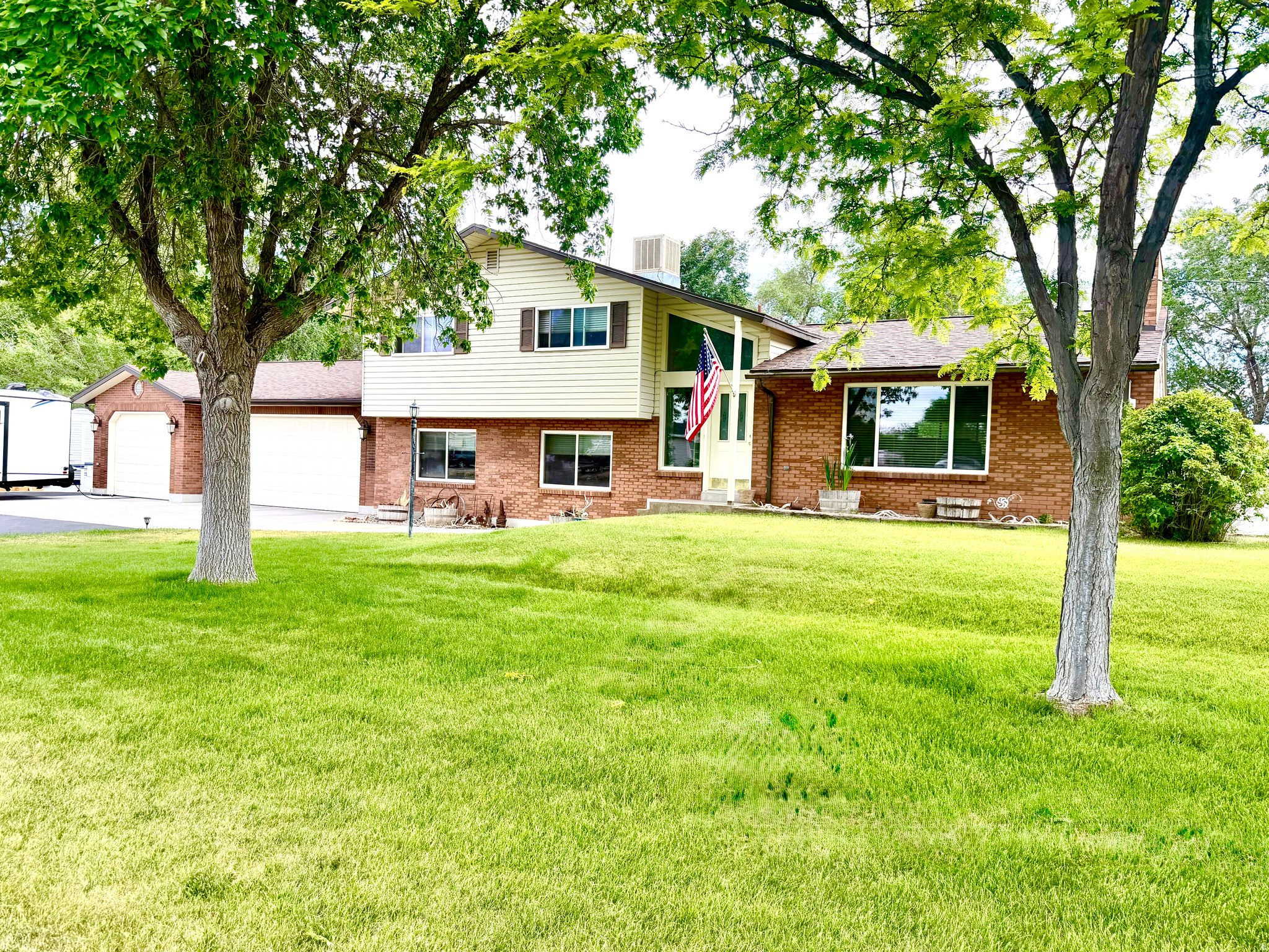 This beautifully updated tri-level home offers the perfect blend of comfort, space, and functionality. Situated on a fully usable 1-acre lot, the property features a finished 3-car garage, ample RV parking with electrical hookup, and plenty of room for all your toys and outdoor activities. Enjoy lower-cost landscape irrigation with your own private water well dedicated to outdoor watering. The fenced acreage provides space for animals, gardening, or simply enjoying the open surroundings. Step outside to relax or entertain under the covered patio while taking in the peaceful setting. Whether you're looking for room to spread out, accommodate animals, or enjoy country-style living with modern updates, this property has it all. All information is deemed reliable. Buyer is advised to obtain independent information.