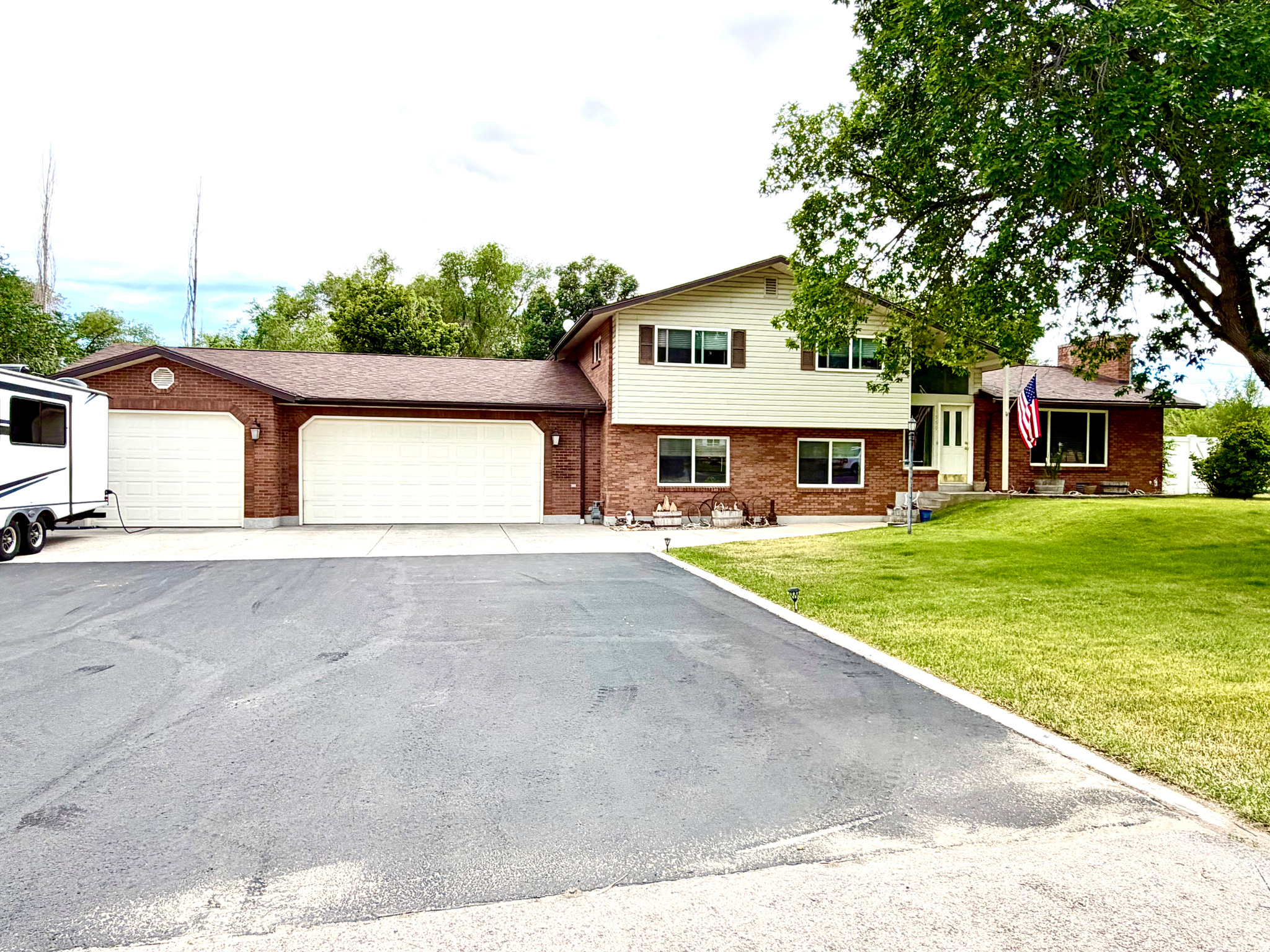 This beautifully updated tri-level home offers the perfect blend of comfort, space, and functionality. Situated on a fully usable 1-acre lot, the property features a finished 3-car garage, ample RV parking with electrical hookup, and plenty of room for all your toys and outdoor activities. Enjoy lower-cost landscape irrigation with your own private water well dedicated to outdoor watering. The fenced acreage provides space for animals, gardening, or simply enjoying the open surroundings. Step outside to relax or entertain under the covered patio while taking in the peaceful setting. Whether you're looking for room to spread out, accommodate animals, or enjoy country-style living with modern updates, this property has it all. All information is deemed reliable. Buyer is advised to obtain independent information.