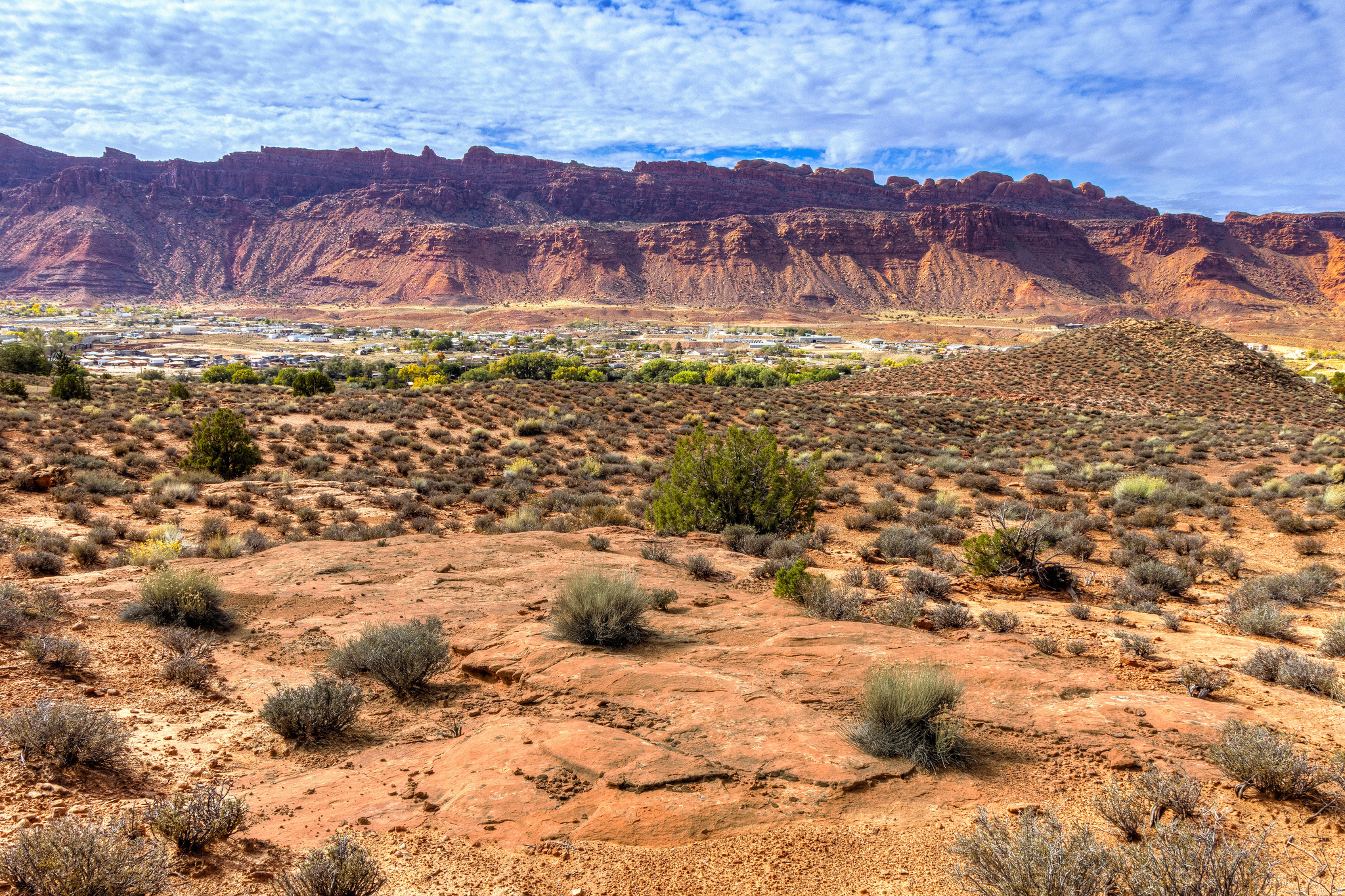 Perched in the peaceful Kayenta Heights community, this 5.22-acre parcel offers a rare blend of serenity, scenery, and convenience. Enjoy panoramic views stretching across Sand Flats, the La Sal Mountains, and the red cliffs of Moab Rim. The property borders public land with an established trail-perfect for a morning hike with your dog right from home. This well-managed subdivision features quality homes, has one of the lowest HOA fees in the county, and a private, quiet setting just nine minutes from Milt's Stop & Eat, downtown shopping and dining. water rights included and well needed. With no city taxes, and wide-open desert vistas, this location feels like your own personal state park-offering privacy and space to build your dream home in Moab's incredible landscapes. See https://kayentaheights.org/ for more HOA information.