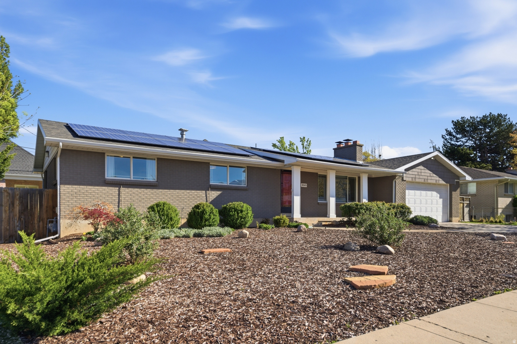 Bright, Spacious & Move-In Ready with Solar + EV Charging. This spacious and inviting property blends comfort, flexibility, and value in all the right ways. With an ideal classic Ranch/Rambler layout featuring 5 bedrooms, 3 bathrooms and Family Rooms on each level. There's room for everyone to live, work, and play. The main-level Great Room, complete with a cozy fireplace, sets the tone for relaxing evenings, while the expansive lower-level Family Room (with a second fireplace!) offers endless possibilities for movie nights, game days, creative space, or all of the above. The bright, refreshed kitchen is the charming hub of the home, filled with natural light and seamlessly flowing out to a fully fenced backyard with covered patio perfect for summer BBQs, entertaining, or simply unwinding while kids and pets play. You'll also love the 2-car garage and abundant storage throughout. Pride of ownership shines in every corner of this well-maintained home. And the extras? They're a game-changer: solar panels, EV charging, and a newer HVAC system help keep your home comfortable and energy-efficient year-round. Space, charm, and smart upgrades--all in a fantastic Millcreek Area location. Come see it for yourself!