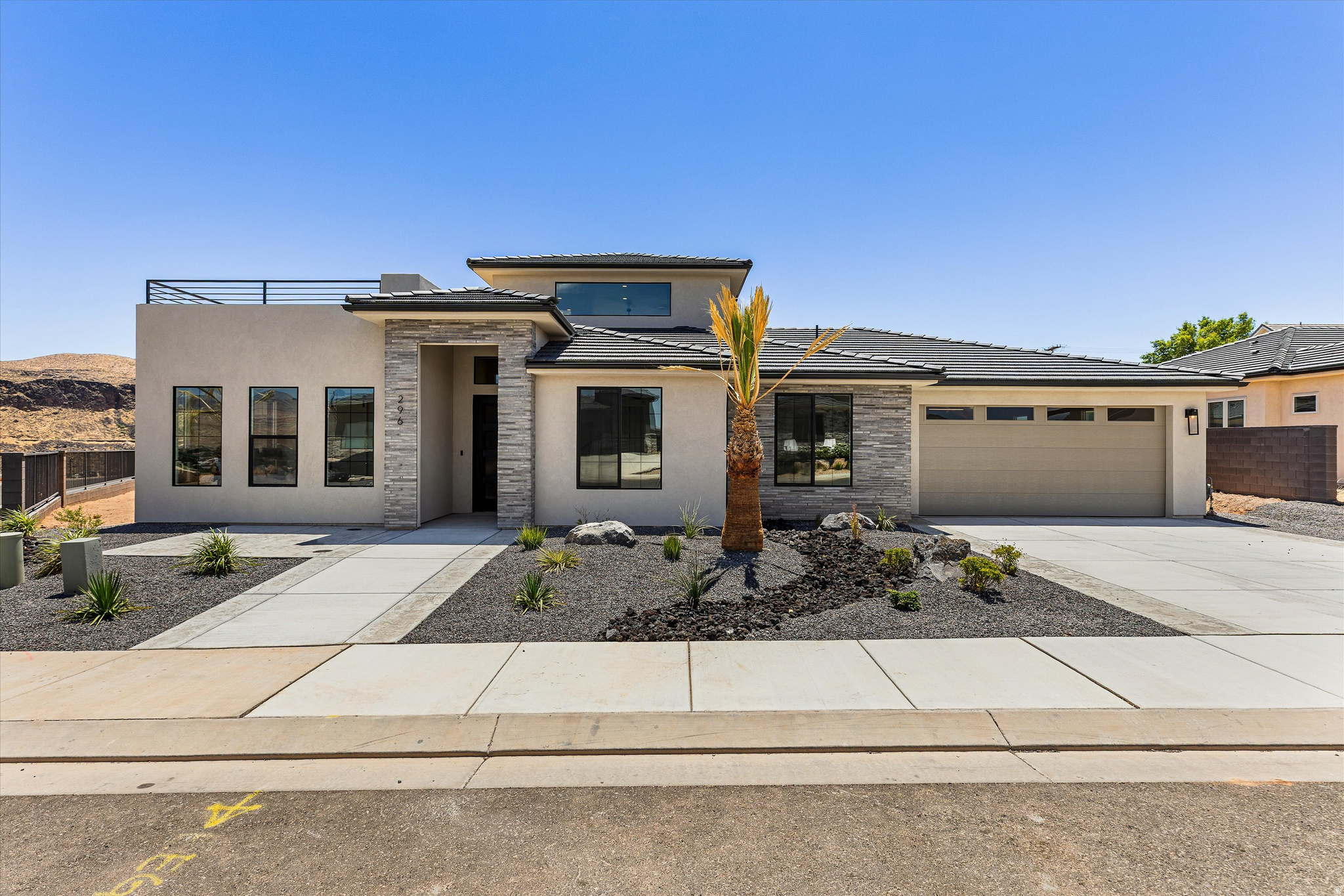 Perched on the bluff above the Virgin River, this exceptional new construction home offers a front-row seat to some of Southern Utah's most breathtaking scenery. Designed to embrace its remarkable setting, expansive windows throughout the home flood the interior with natural light while perfectly framing the stunning bluff and river views.  The thoughtfully designed floor plan features 3 bedrooms, 2 bathrooms, and an open-concept living space that feels both spacious and inviting. The heart of the home is the beautifully appointed kitchen, complete with a generous walk-in pantry and seamless flow into the dining and living areas--ideal for entertaining or everyday living.  Adventure enthusiasts will appreciate the oversized double tandem garage, featuring a convenient roll-up rear door that provides direct access to the backyard, making it easy to store and enjoy ATVs, bikes, and other recreational toys.  Upstairs, a versatile bonus room offers endless possibilities for a media room, home office or fitness space. Just beyond, a sprawling rooftop deck creates the ultimate outdoor living experience, where panoramic views of the Virgin River and surrounding red rock bluffs provide an unforgettable backdrop for relaxing, entertaining, and enjoying spectacular Southern Utah sunsets.  The spacious backyard has been intentionally left as a blank canvas, allowing the new owner to create their dream outdoor retreat. With ample room for a pool, spa, outdoor kitchen, putting green, or custom landscaping design, the possibilities are limited only by your imagination.  Combining modern design, functional spaces, and unbeatable views, this bluffside retreat is a rare opportunity to experience luxury living in one of the area's most scenic settings.