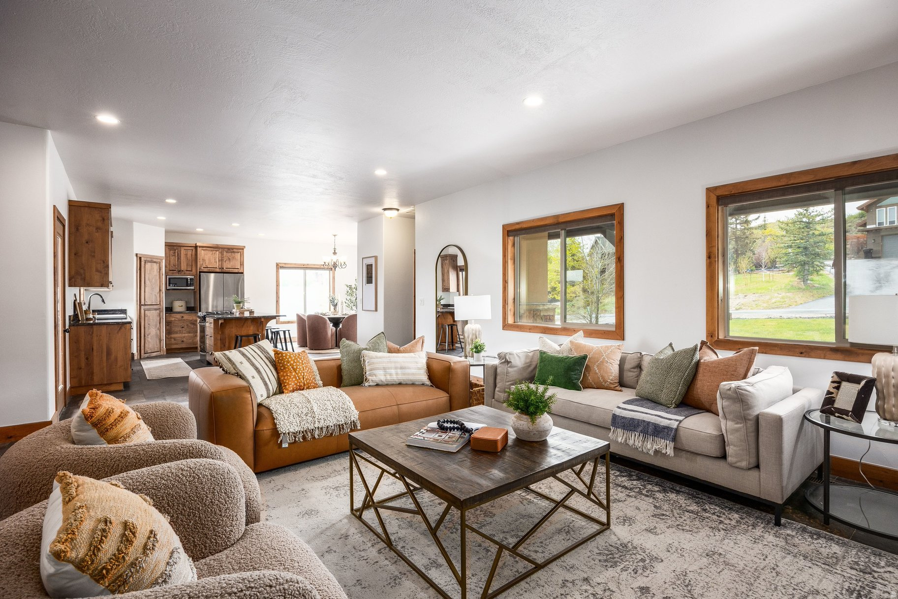 Located within the coveted Park City school district, this beautifully maintained home, tucked along a quiet street in the Highland Estates neighborhood, strikes a rare balance between privacy and convenience. Set on an expansive .89-acre lot, it offers a true sense of space with room to relax, grow, and take in the surrounding natural beauty. The thoughtfully designed floor plan features a main-level primary suite and a bright, walk-out lower level with two additional bedrooms and a spacious family room--ideal for guests or flexible living. Fresh interior paint and brand-new carpet (2026) give the home a crisp, move-in-ready feel, while quality finishes throughout include slate flooring, granite countertops, alder cabinetry, stainless steel appliances, travertine tile, and European glass accents. Zoned for horses and livestock, the generous lot also includes a versatile 1,000-square-foot barn, perfect for a workshop, RV storage, hobby space, or more. Located within the Park City School District and just minutes from Kimball Junction and historic Main Street, this property offers the best of quiet mountain living with effortless access to dining, shopping, and year-round recreation. Furnishings are staged. The lower level is virtually staged, and the "office" is a third bedroom.
