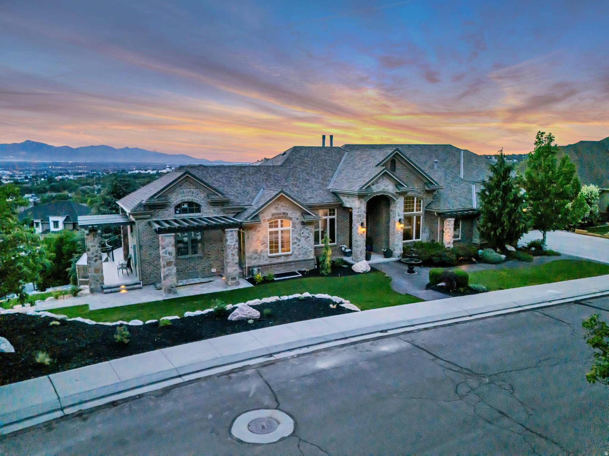 Perched high on the east side, this beautifully remodeled home finished with high-end upgrades throughout, offers sweeping valley views and a thoughtfully designed open floor plan. The spacious kitchen features top-of-the-line appliances, a butler's pantry, and a large bar with seating for ten. The family room boasts vaulted ceilings, expansive windows, and  full wall sliding doors that open to a wraparound deck for seamless indoor-outdoor living. The daylight basement includes a second kitchen and a dedicated fitness room.  Car enthusiasts and hobbyists alike will appreciate the extraordinary 6-car garage, complemented by an additional dedicated space for tools and equipment.  A refined property with exceptional views-schedule your showing today.