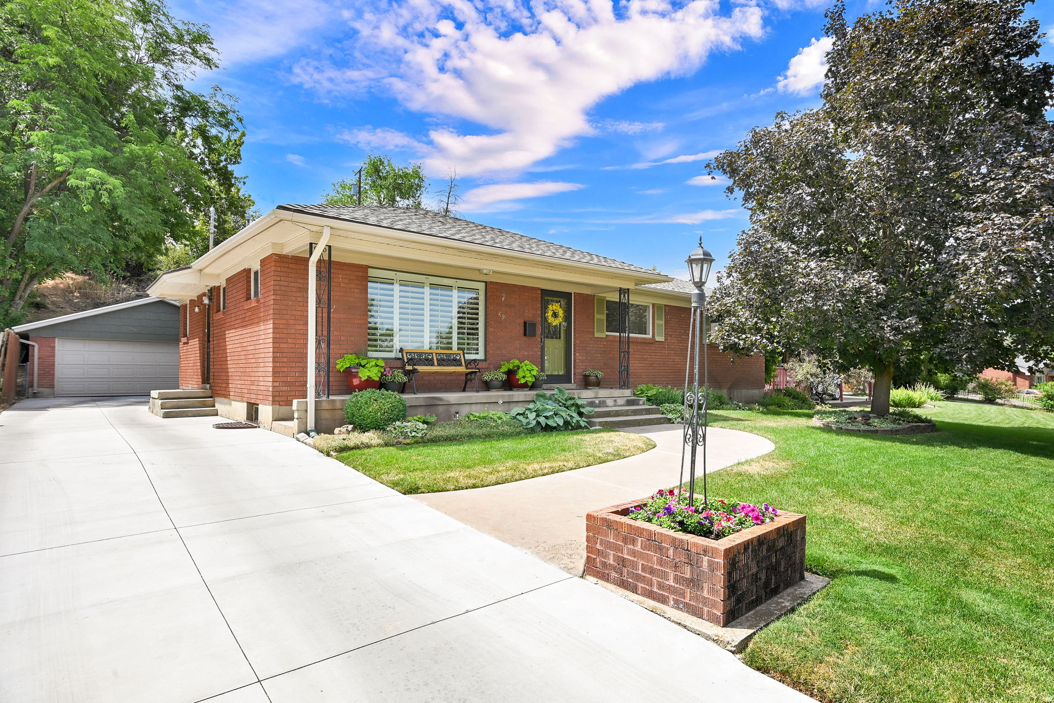 Beautifully maintained and updated spacious 5-bedroom rambler located in a great area of Ogden, within walking distance of the newly built Liberty Elementary School, and just down the street you'll find Orchard Park. This immaculate home features solid maple kitchen cabinets, real hardwood floors throughout the upstairs, abundant storage, and an easy, comfortable floor plan that makes it a wonderful family home.  Pride of ownership is evident throughout. Recent updates include the central air conditioning system, a 95% efficient furnace, and the concrete driveway and back patio. The home's curb appeal is enhanced by mature landscaping and a beautiful shade tree in the front yard.  The private backyard is a true highlight, featuring a covered patio, newer storage shed, and a workshop area in the back of the garage. Whether you're relaxing with family or entertaining friends, this secluded outdoor space offers the perfect setting. Clean, beautiful, and move-in ready, this home offers comfort, functionality, and easy living in one of Ogden's most convenient locations.