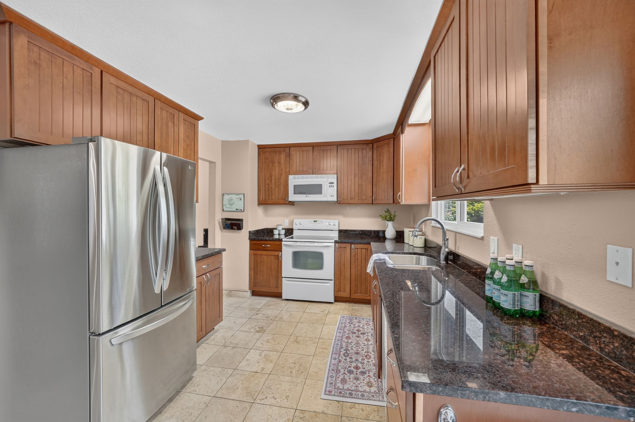 Charming and conveniently located in the heart of Sandy! This well maintained split-entry home features 3 bedrooms, including a spacious primary suite with a private bathroom, 2 full bathrooms, 2 large living rooms, and a spacious 2-car garage. One of the living areas offers the flexibility to be used as a fourth bedroom, office, or bonus space (without a closet). Enjoy a functional floor plan with comfortable living spaces, abundant natural light, and plenty of room to spread out. Situated in a prime location, you'll love being just minutes from shopping, dining, entertainment, parks, and quick access to I-15, making commuting a breeze. Whether you're a first time homebuyer, looking to downsize, or searching for a great investment opportunity, this home offers comfort, convenience, and incredible potential in one of Sandy's most desirable areas. Don't miss your chance to make it yours!