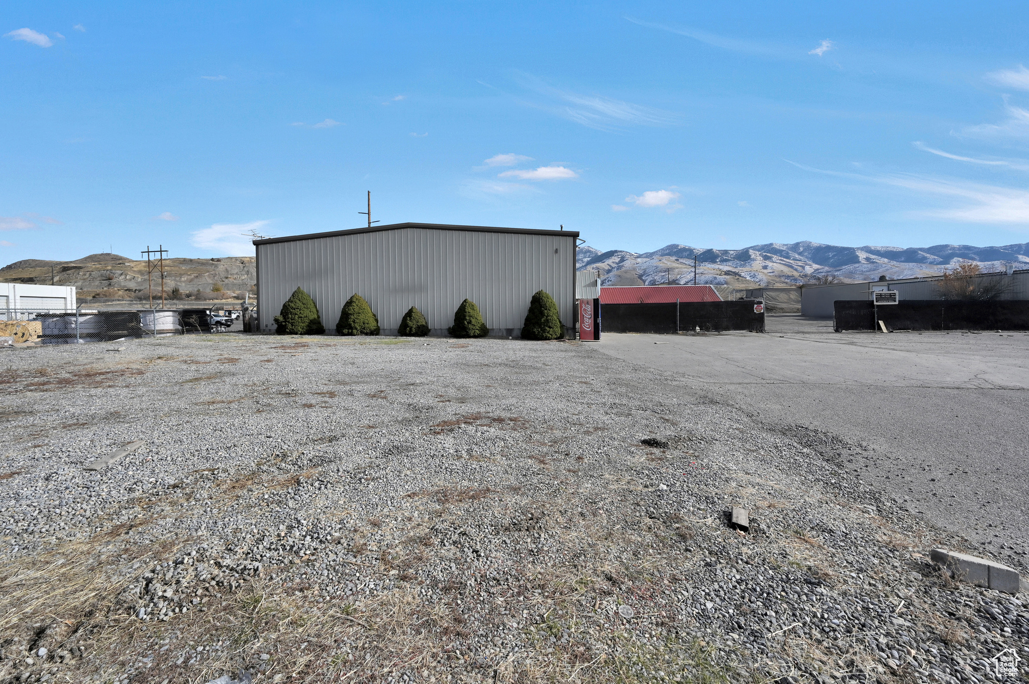 Incredible industrial opportunity right off Highway 91 in the heart of Smithfield! This versatile property features a dedicated retail storefront, a spacious main shop with loft space, and a detached shop-providing abundant room for storage, operations, or expansion. With dual highway approaches, traffic flow and access to the fully fenced rear lot couldn't be more convenient. Set on 2.26 acres, this property is equipped with three-phase power and multiple shop/work areas, making it ideal for a wide range of business uses. Whether you're looking for retail visibility, workshop functionality, or large-scale storage, the possibilities are endless. Don't miss your chance to own this prime commercial/industrial space-call today to schedule your private showing!