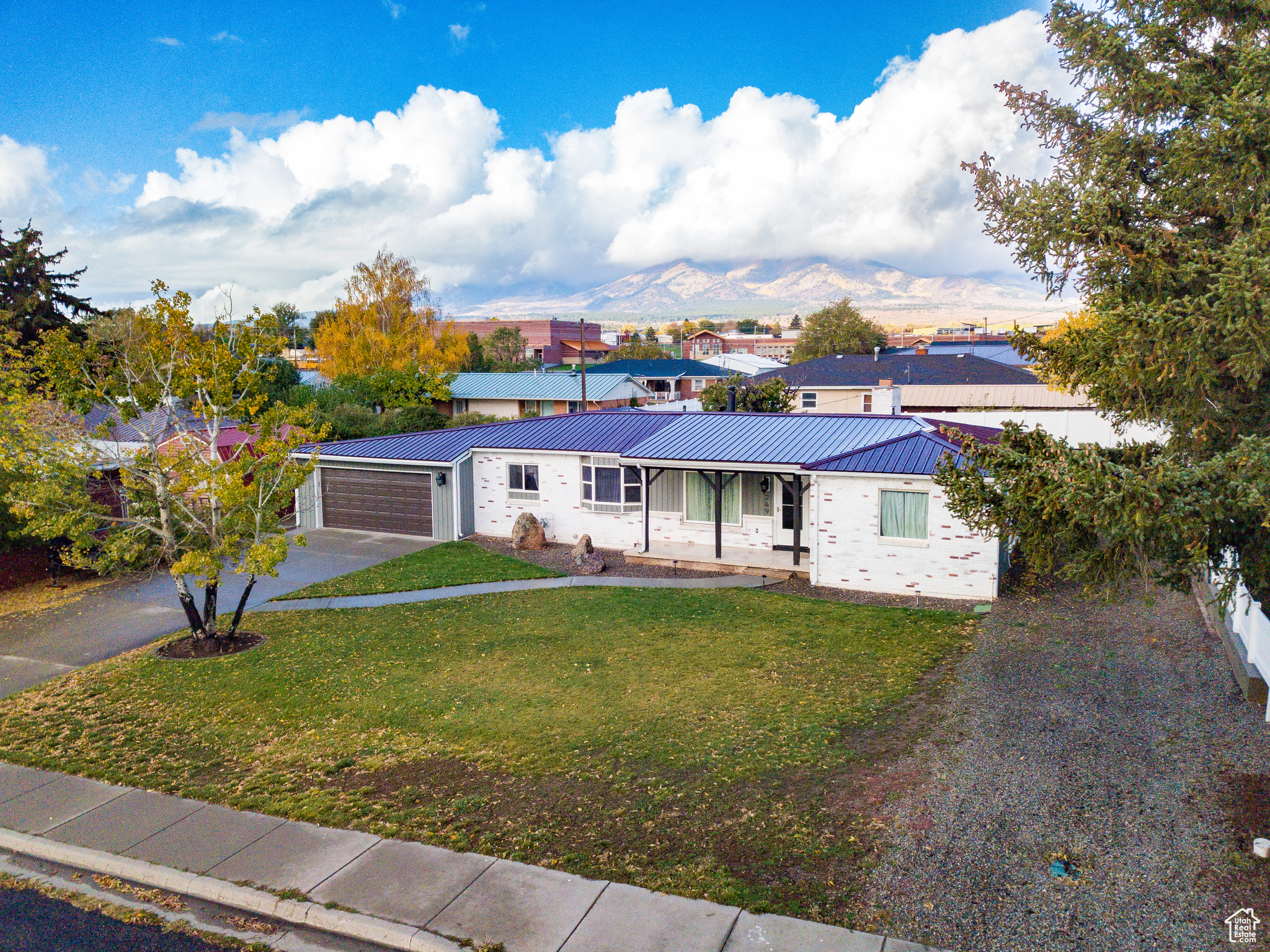 This 3 bed, 2 bath home has an open floorplan and was extensively remodeled five years ago including both bathrooms: one features a large walk-in shower, and the other with a deep tub. You'll also find an ample amount of built-in storage throughout the home, as well as a brand new water heater, and brand new carpet and floor coverings. The home has a metal roof and a french drain system installed underneath the house for superior water management. Enjoy comfort year-round with three independent sources of heat: a cozy gas log fireplace, a traditional wood-burning fireplace, and four newly installed mini-split units for highly efficient electric heating and cooling. Outdoor living is private and enjoyable with a covered porch, a six-foot fence, a mature cherry tree, an open patio area, and a poured cement pad suitable for a shed, grill station, or extra seating.